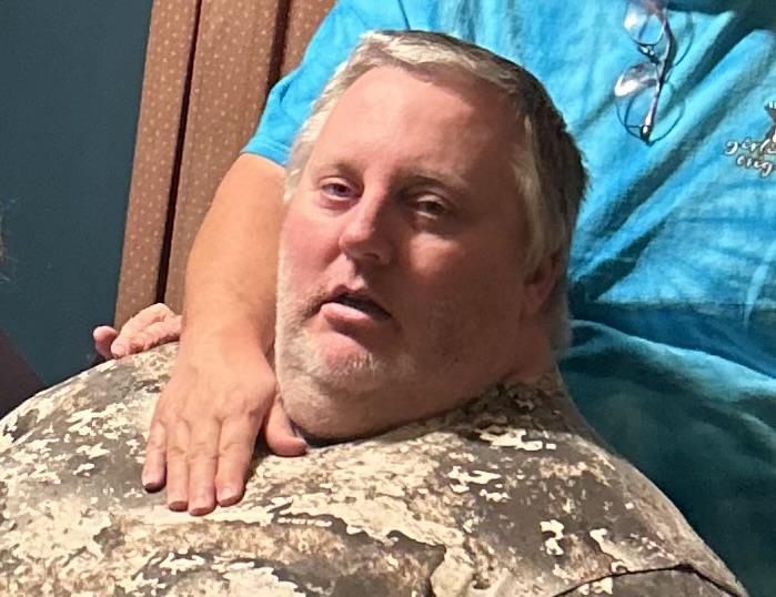A man with a hand on his neck