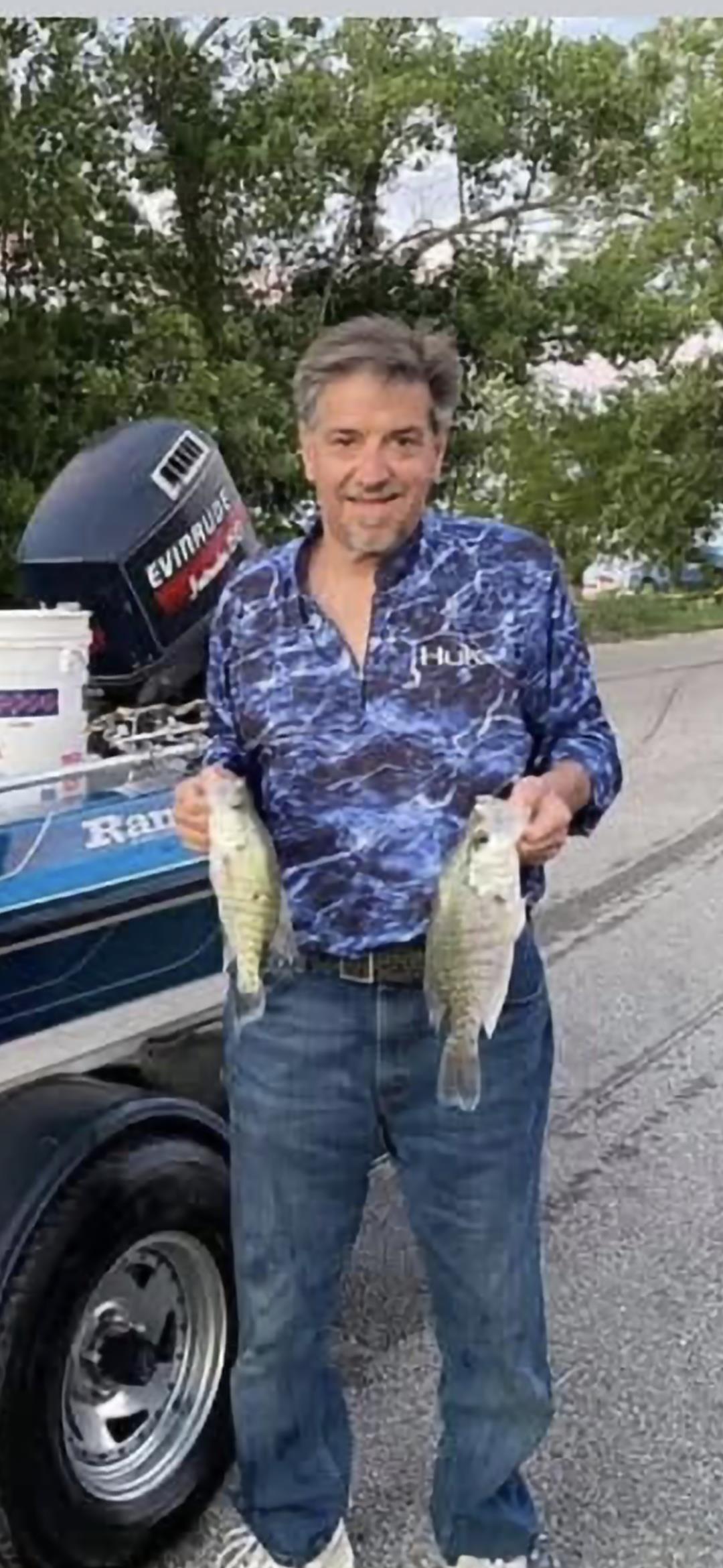 A man holding two fish