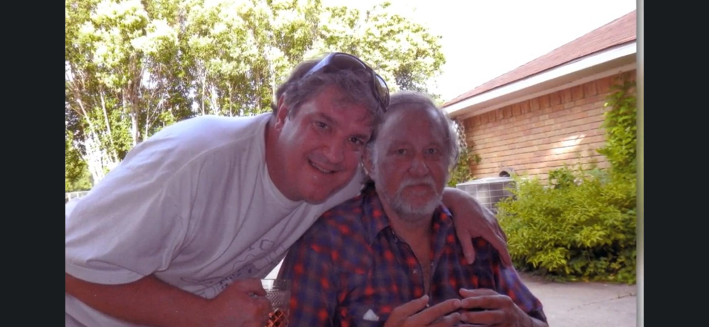 A man and a man posing for a picture