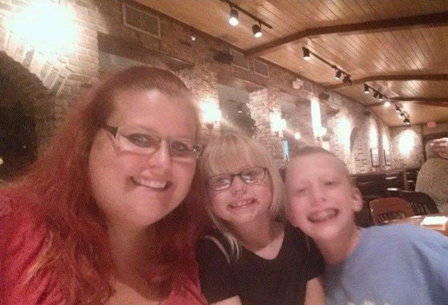 A woman and two children posing for a selfie