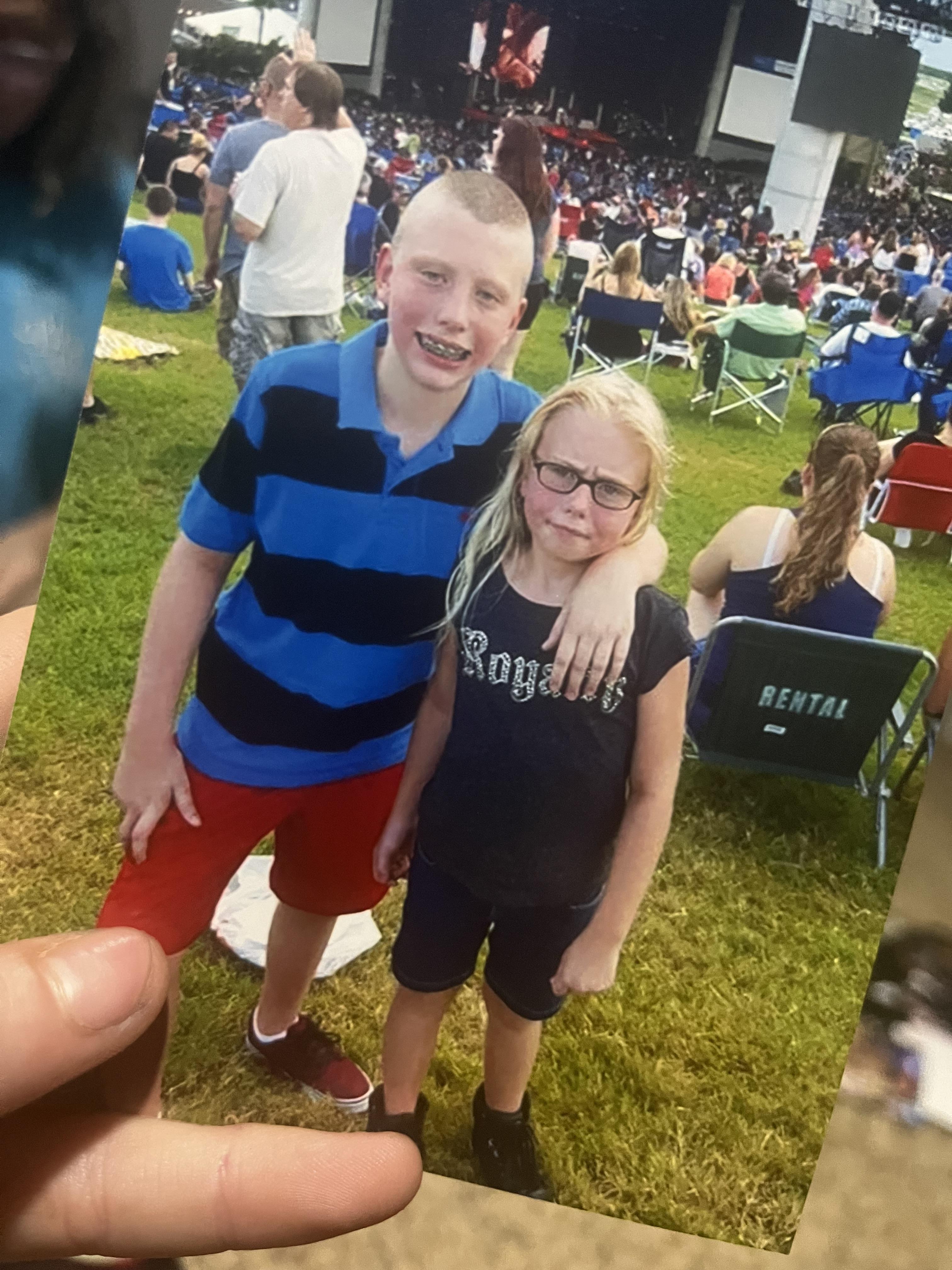 A boy and girl posing for a picture