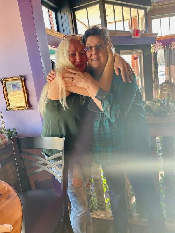 Two women hugging each other