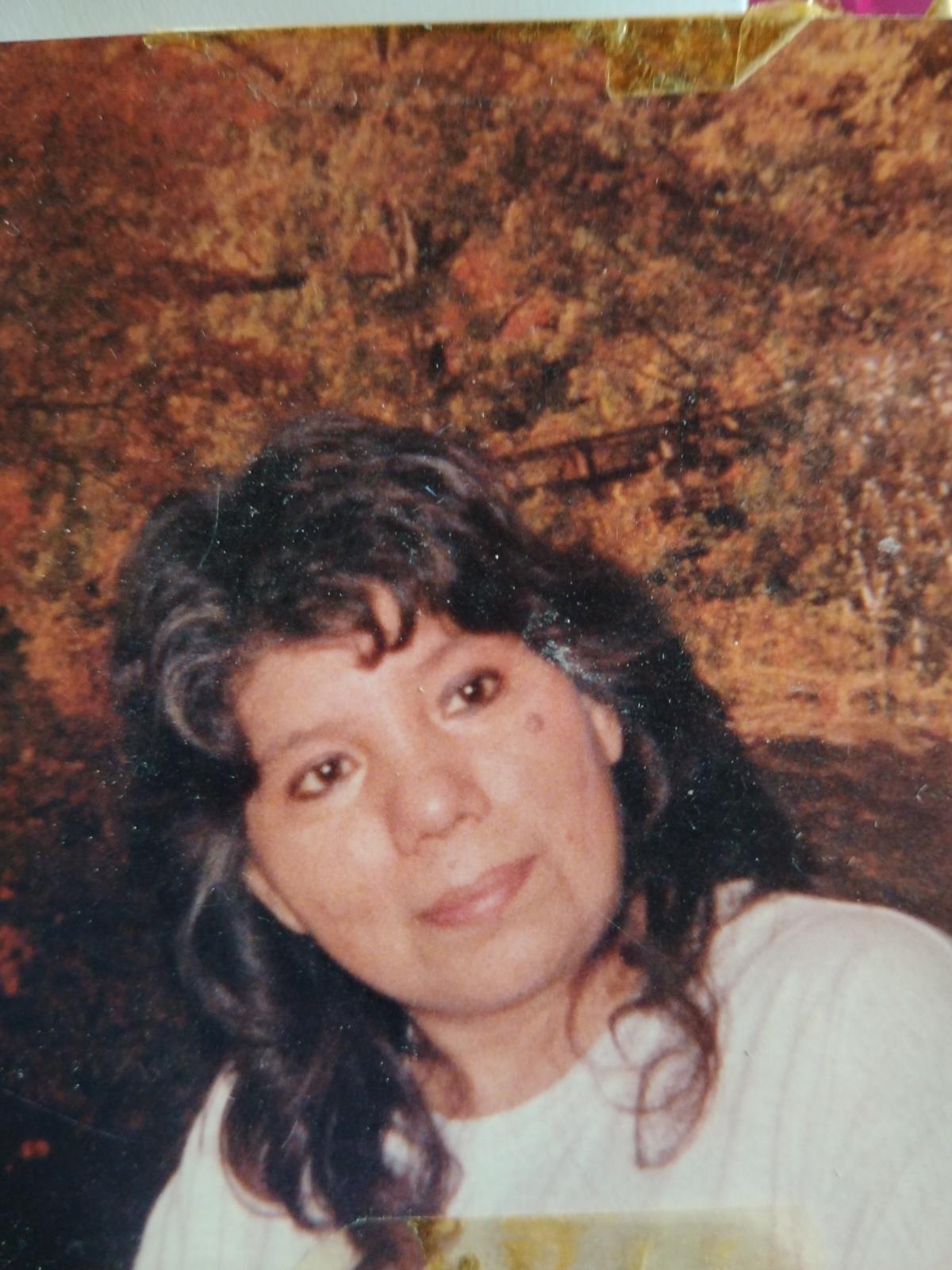 A woman with long hair smiling