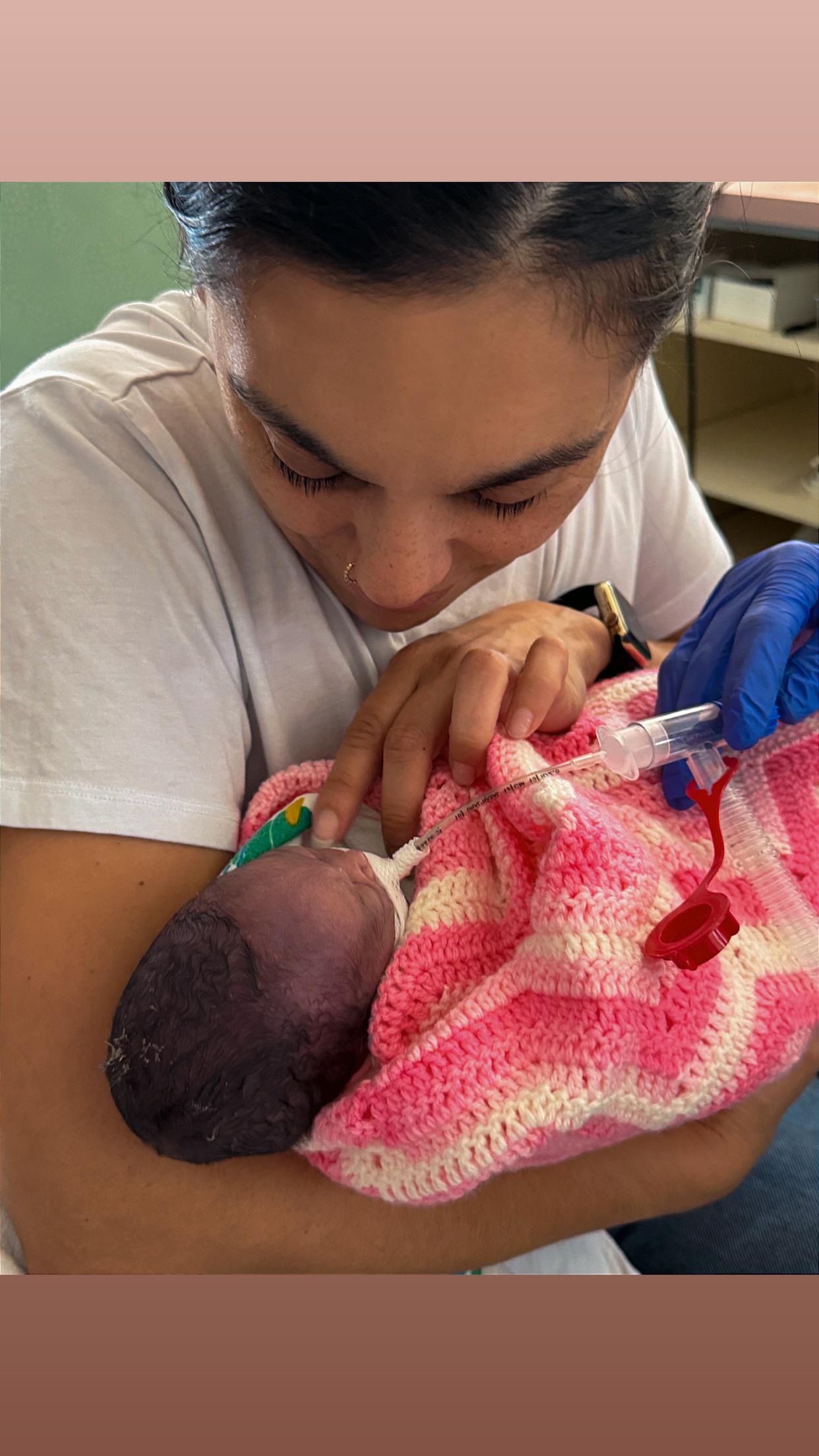 A woman holding a baby