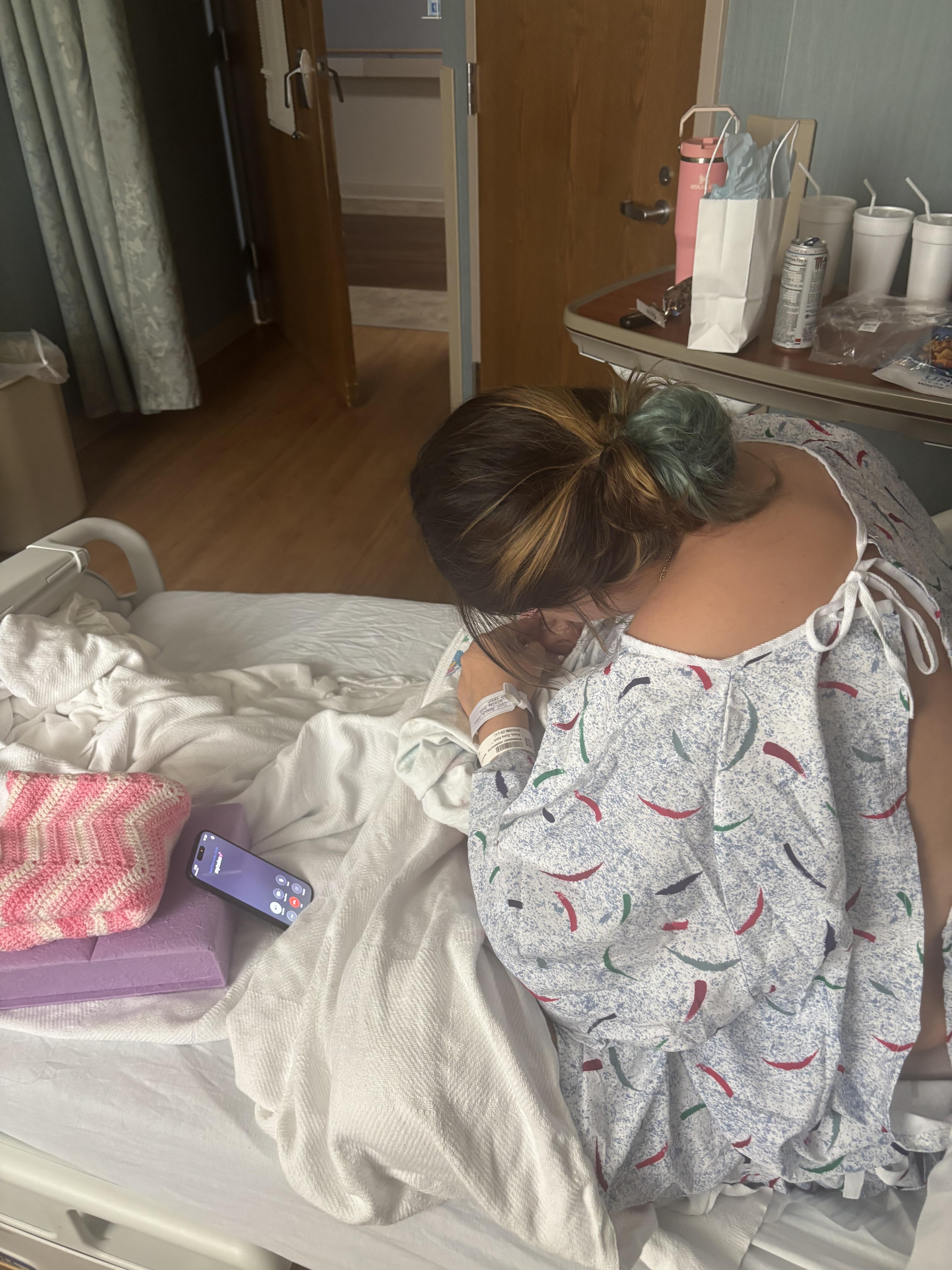 A woman in a hospital gown
