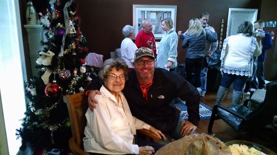 A man and woman sitting in a chair
