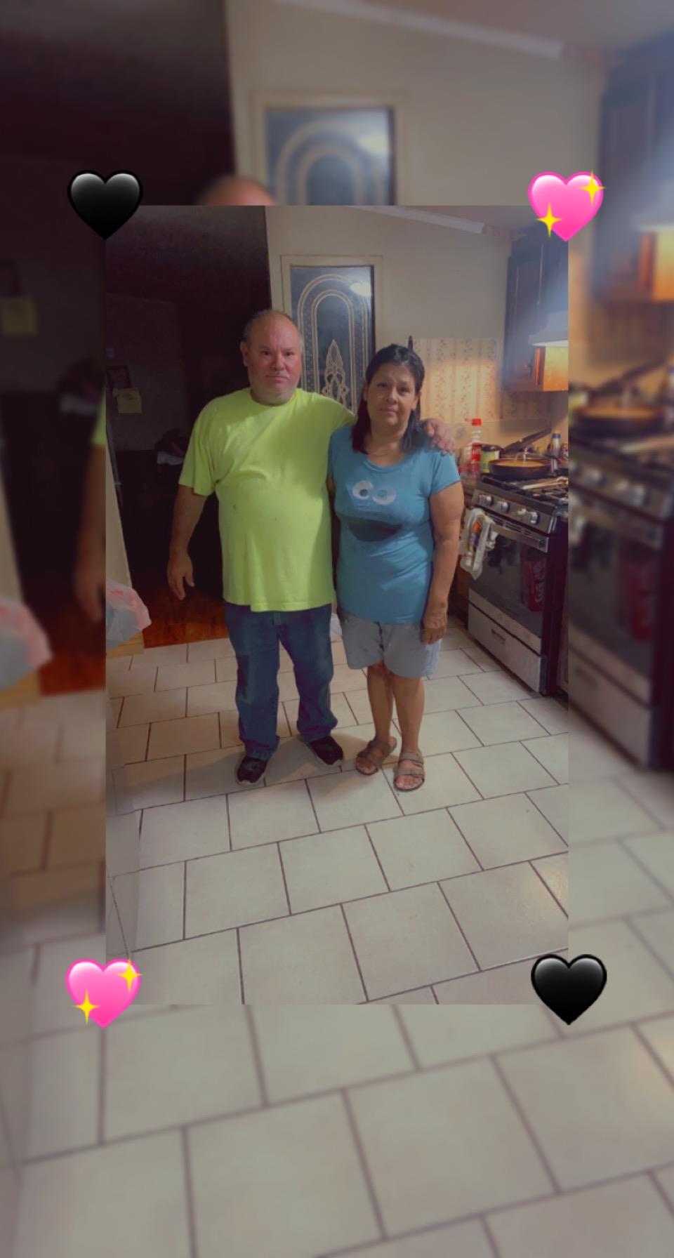 A man and woman standing in a kitchen