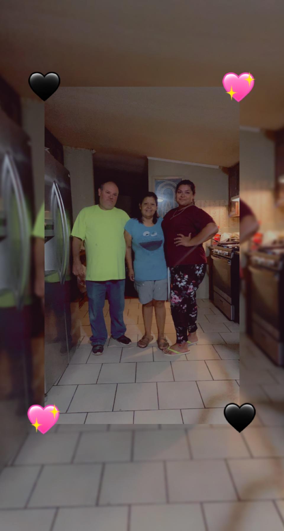 A group of people standing in a kitchen