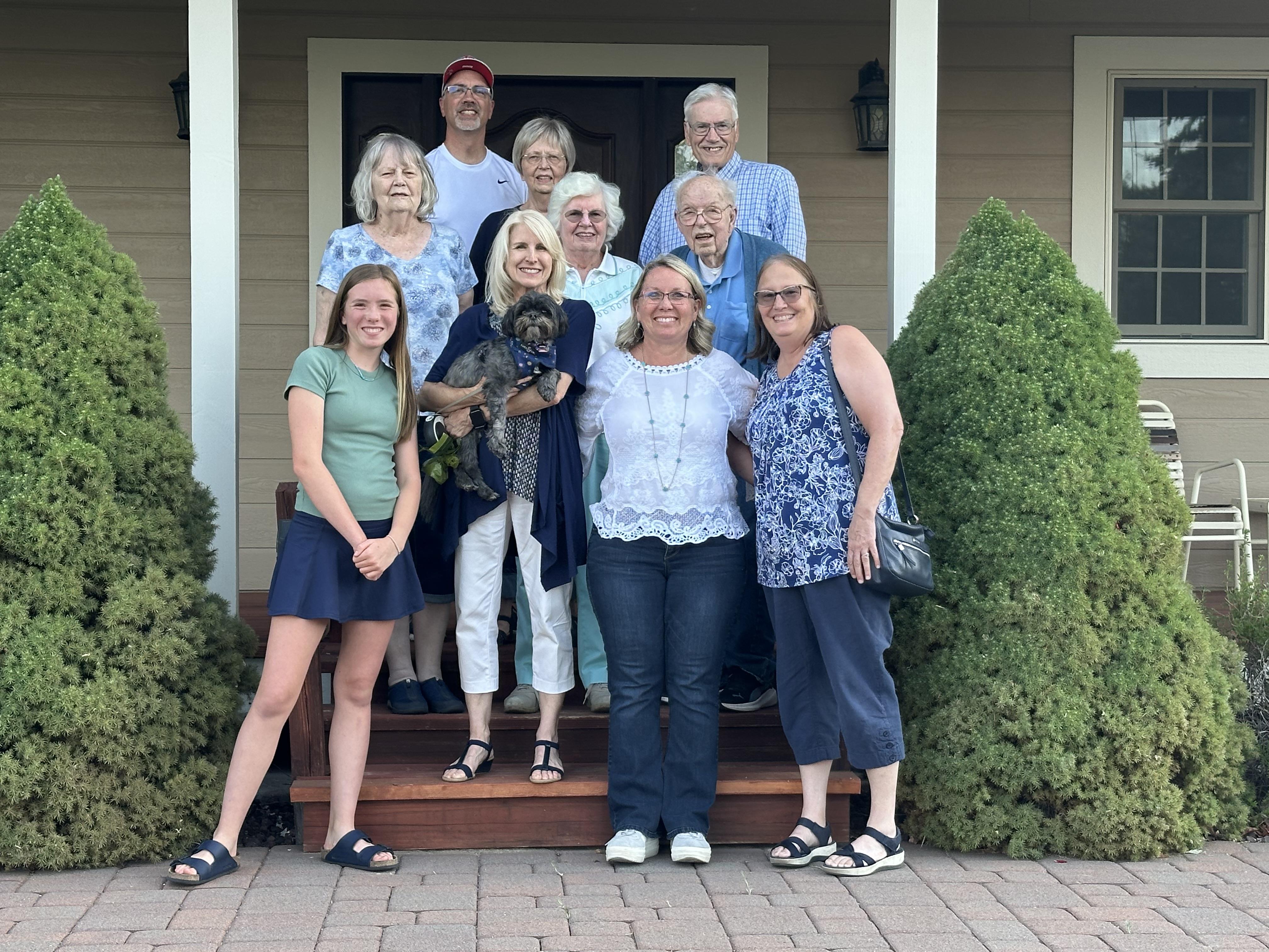 A group of people standing on a porch