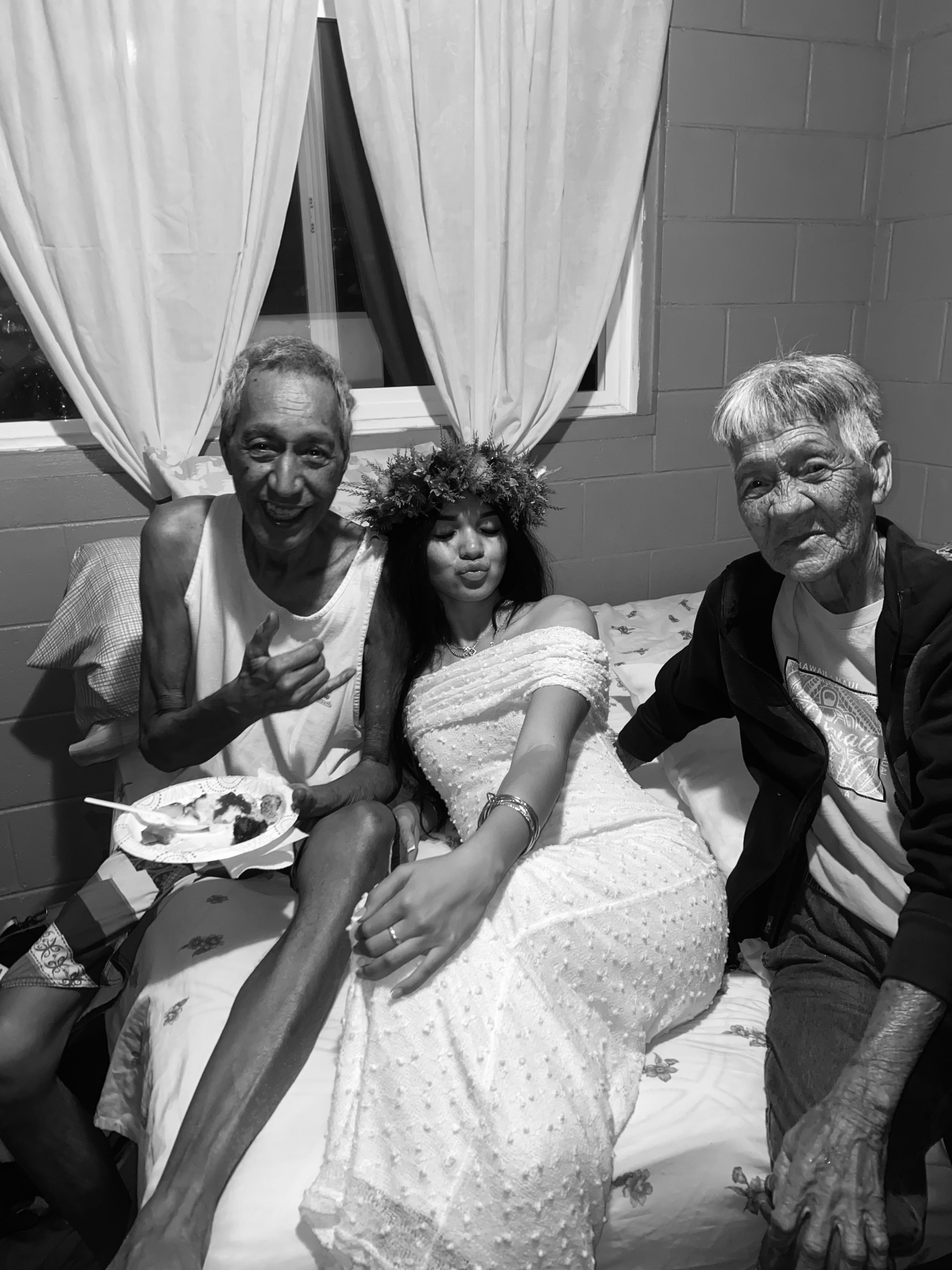 A group of people sitting on a bed