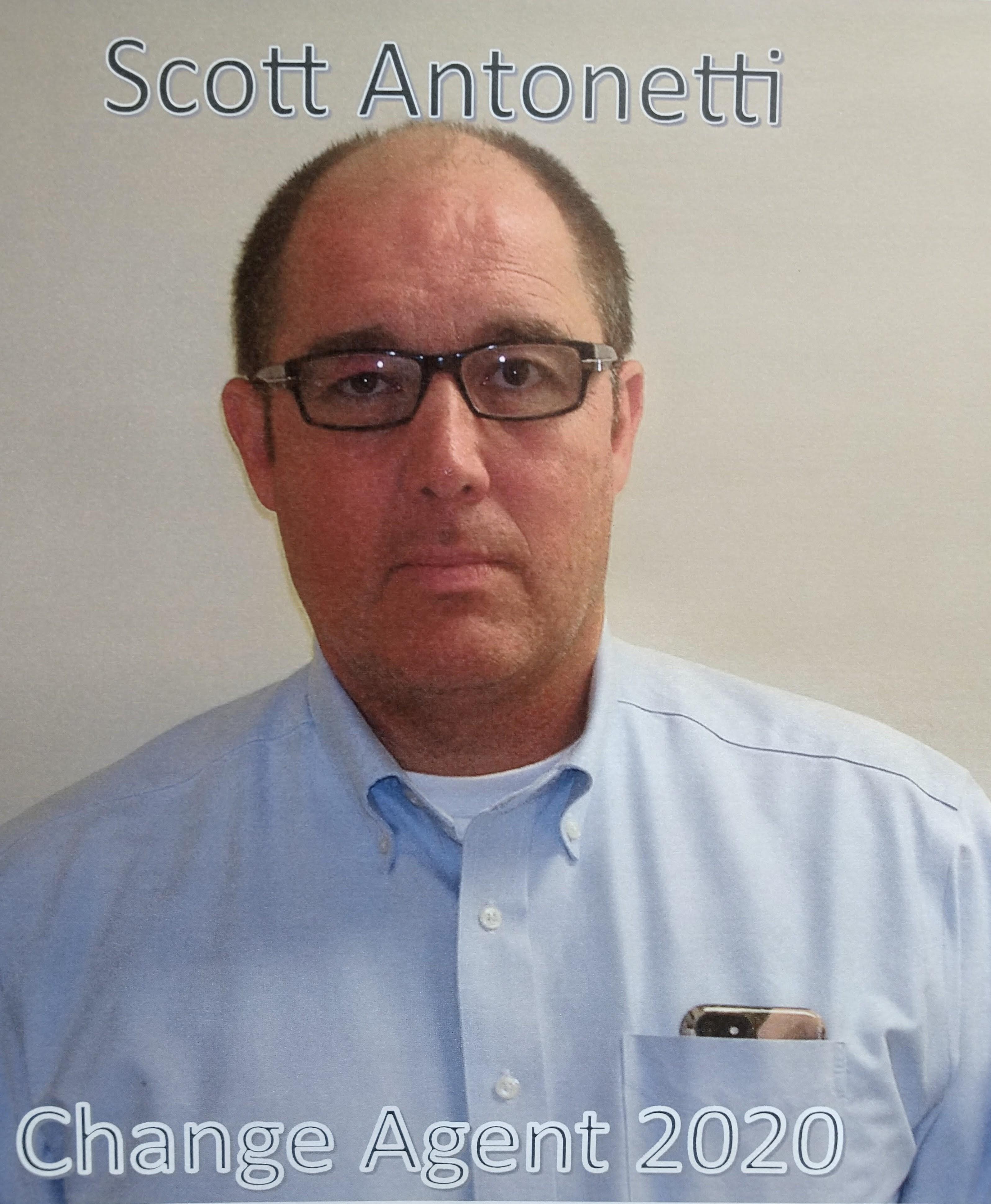 A man wearing glasses and a blue shirt