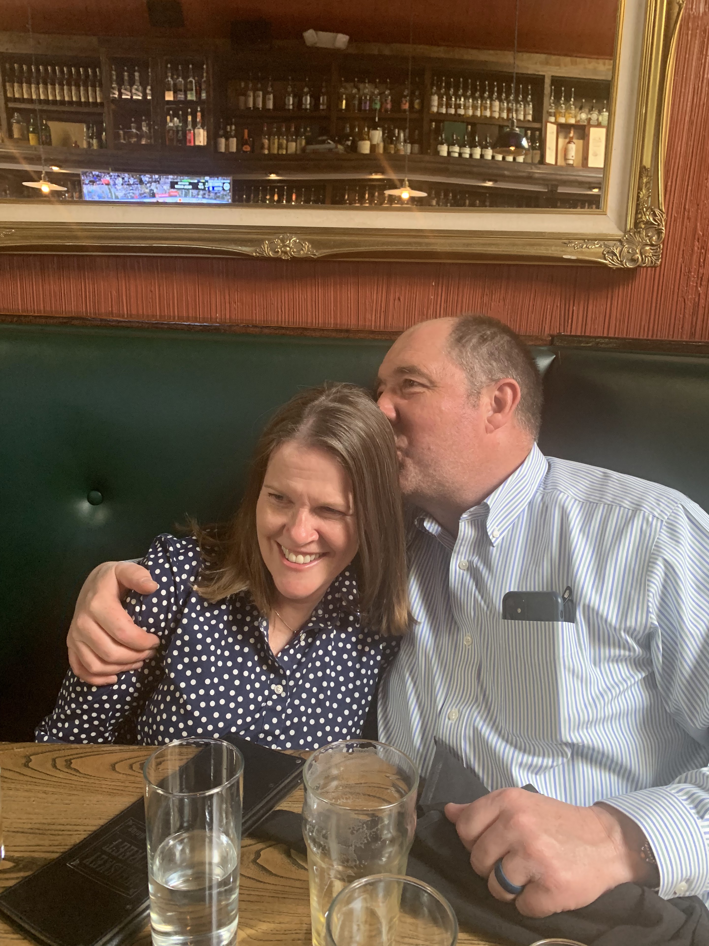 A man kissing a woman's cheek