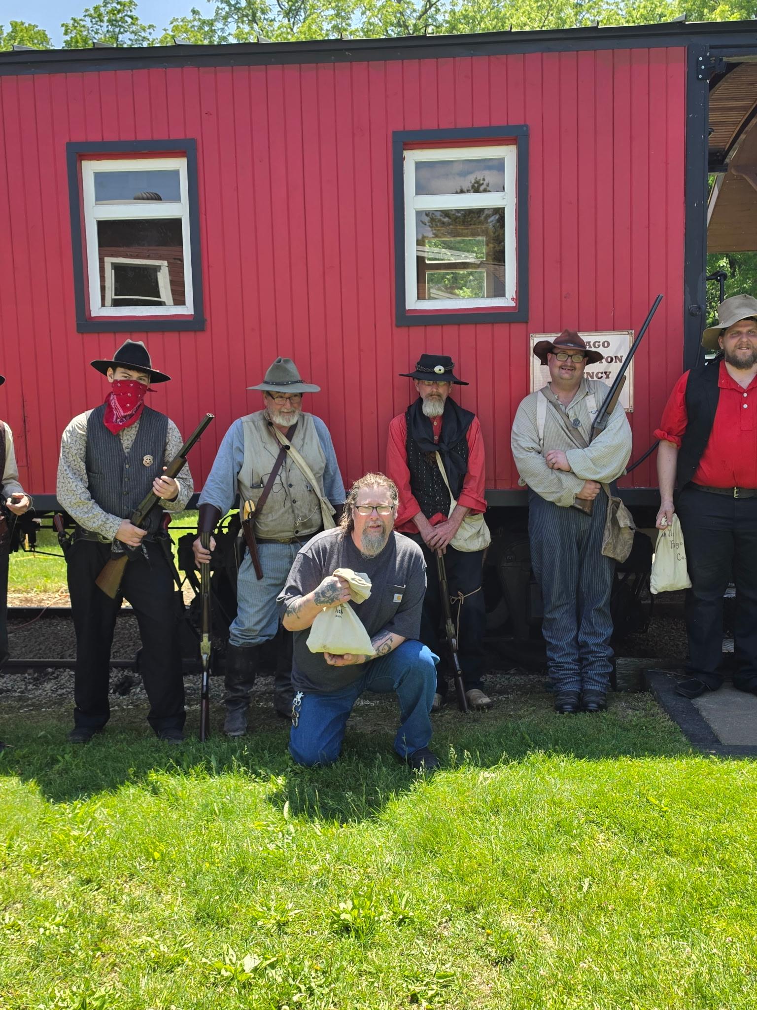 A group of men in clothing posing for a photo
