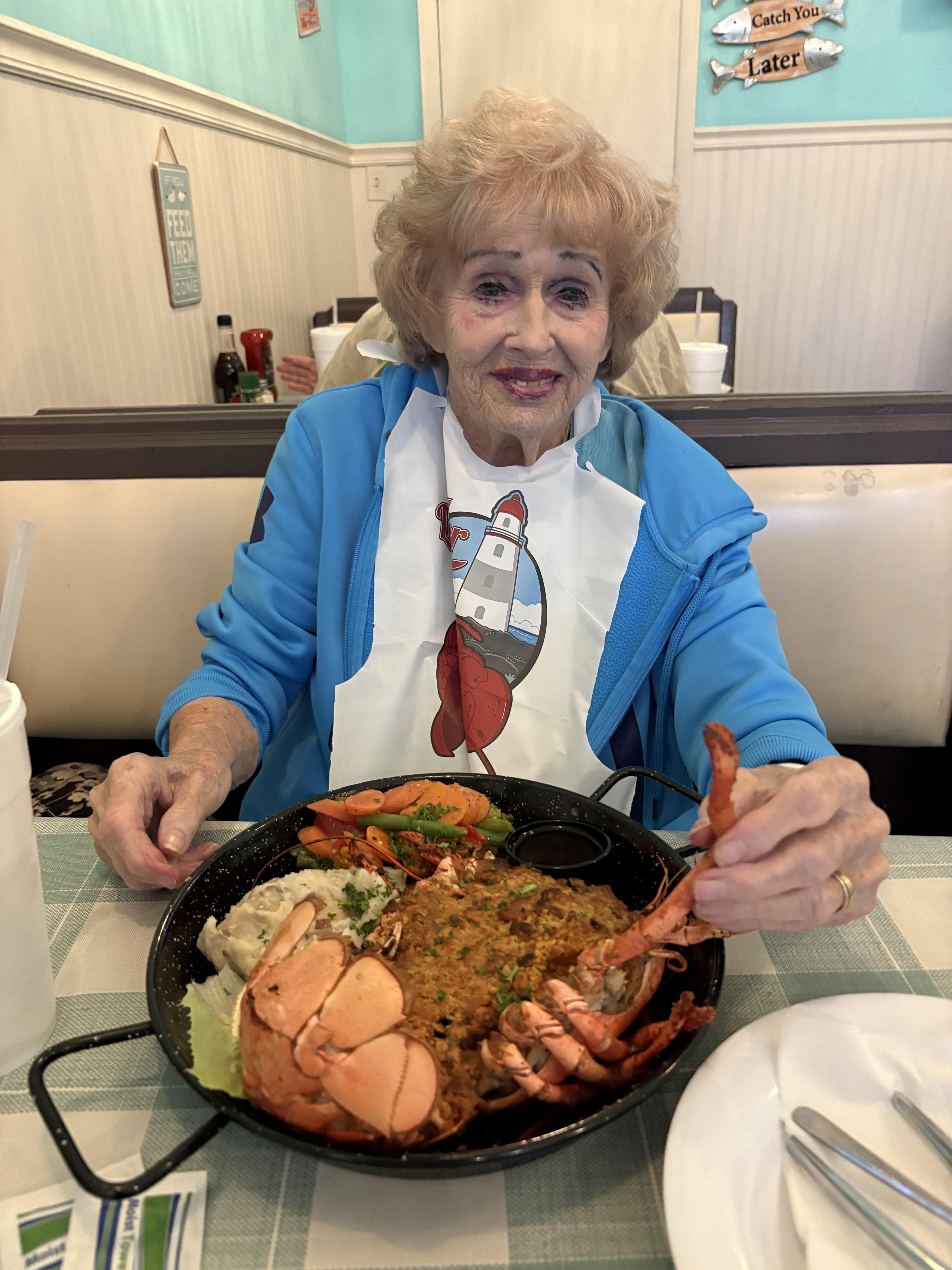 A woman sitting at a table with a plate of food