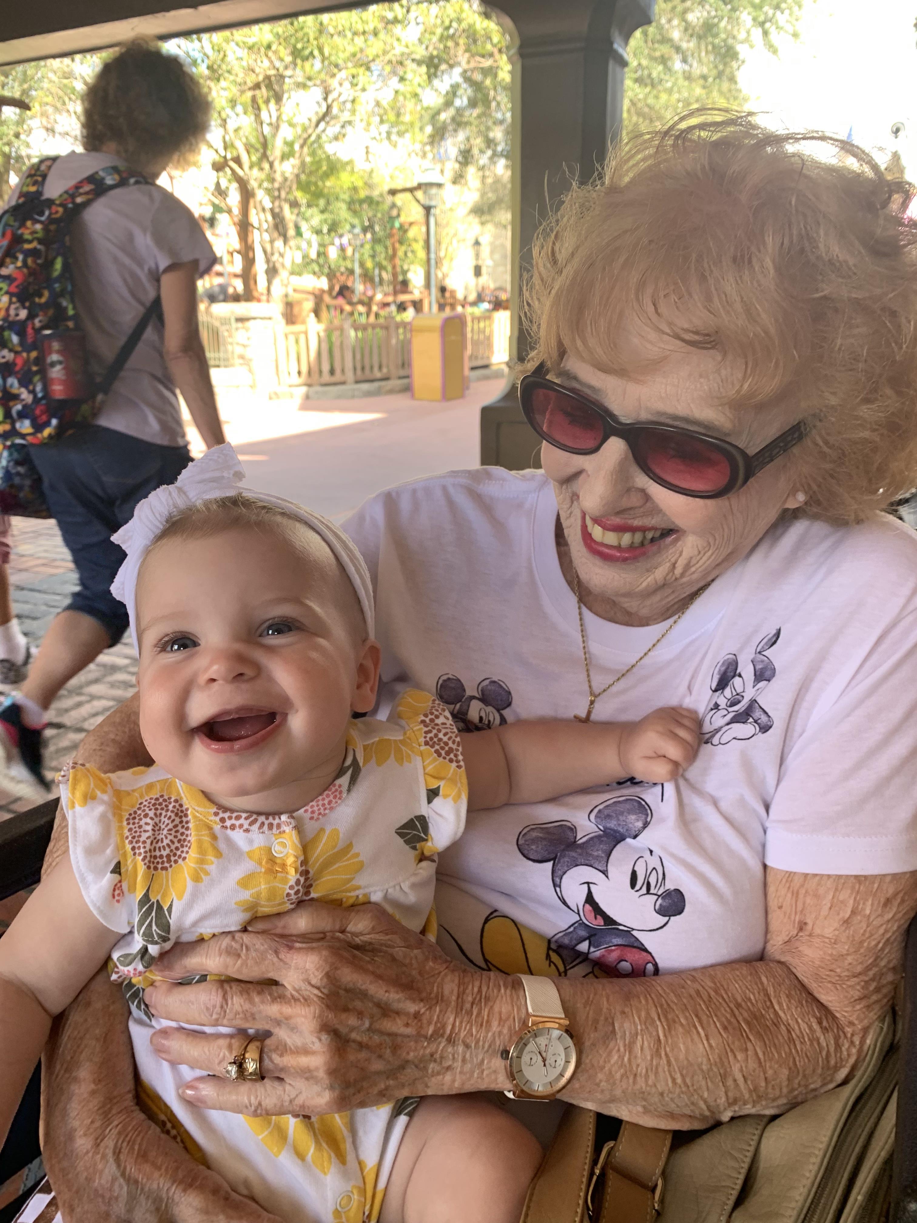 An older woman holding a baby