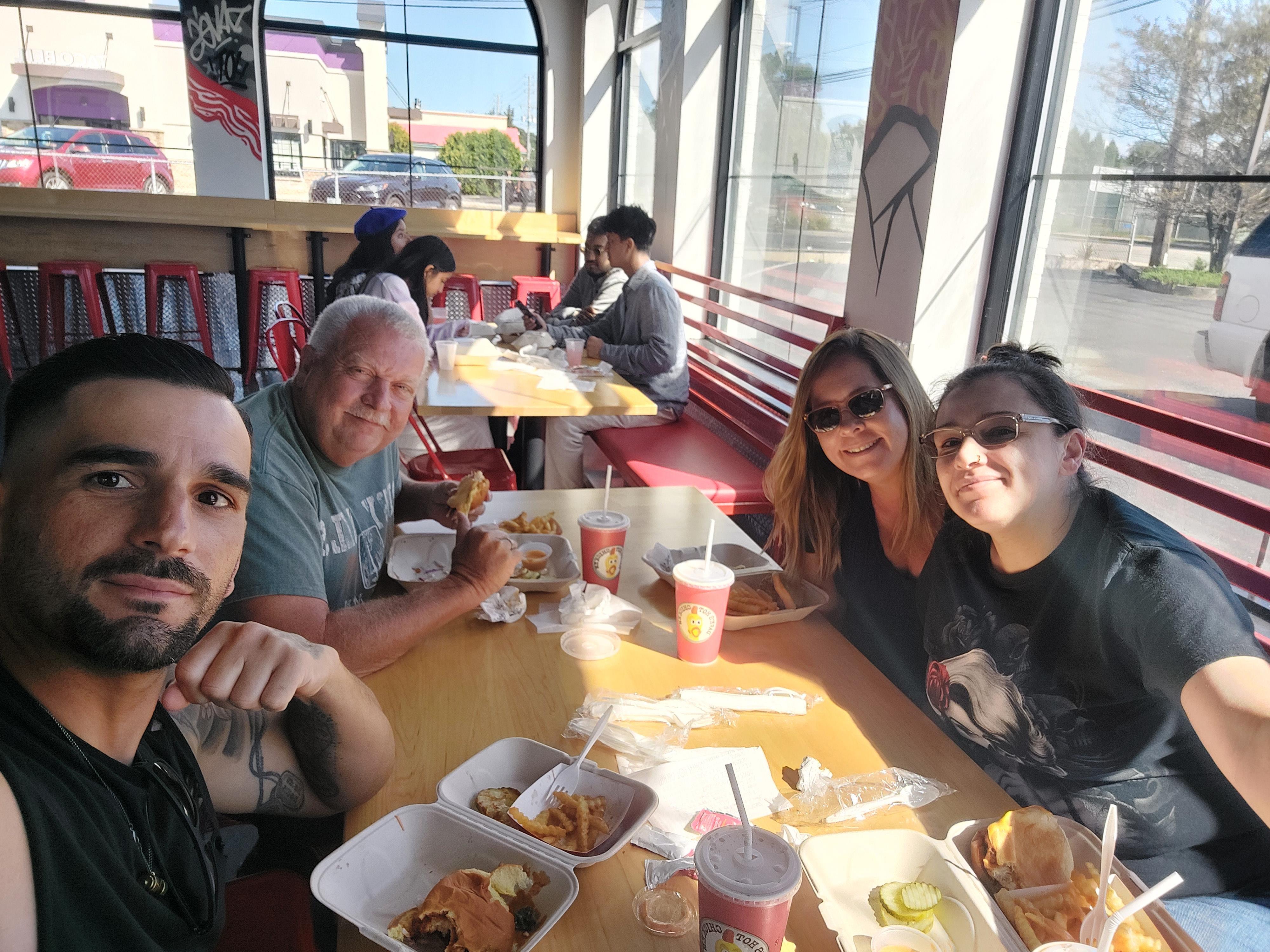 A group of people sitting at a table with food