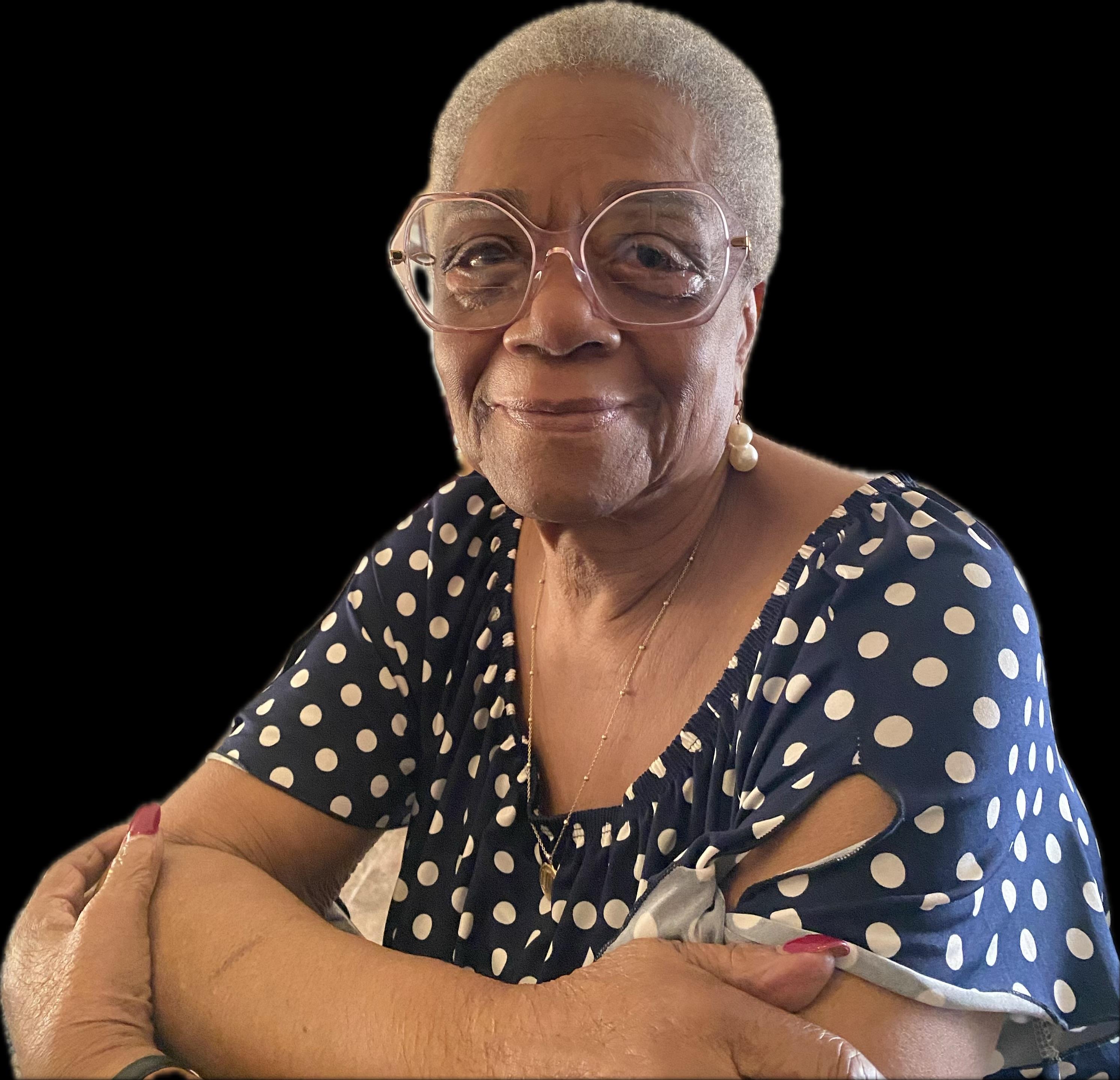 A woman with glasses and a polka dot shirt