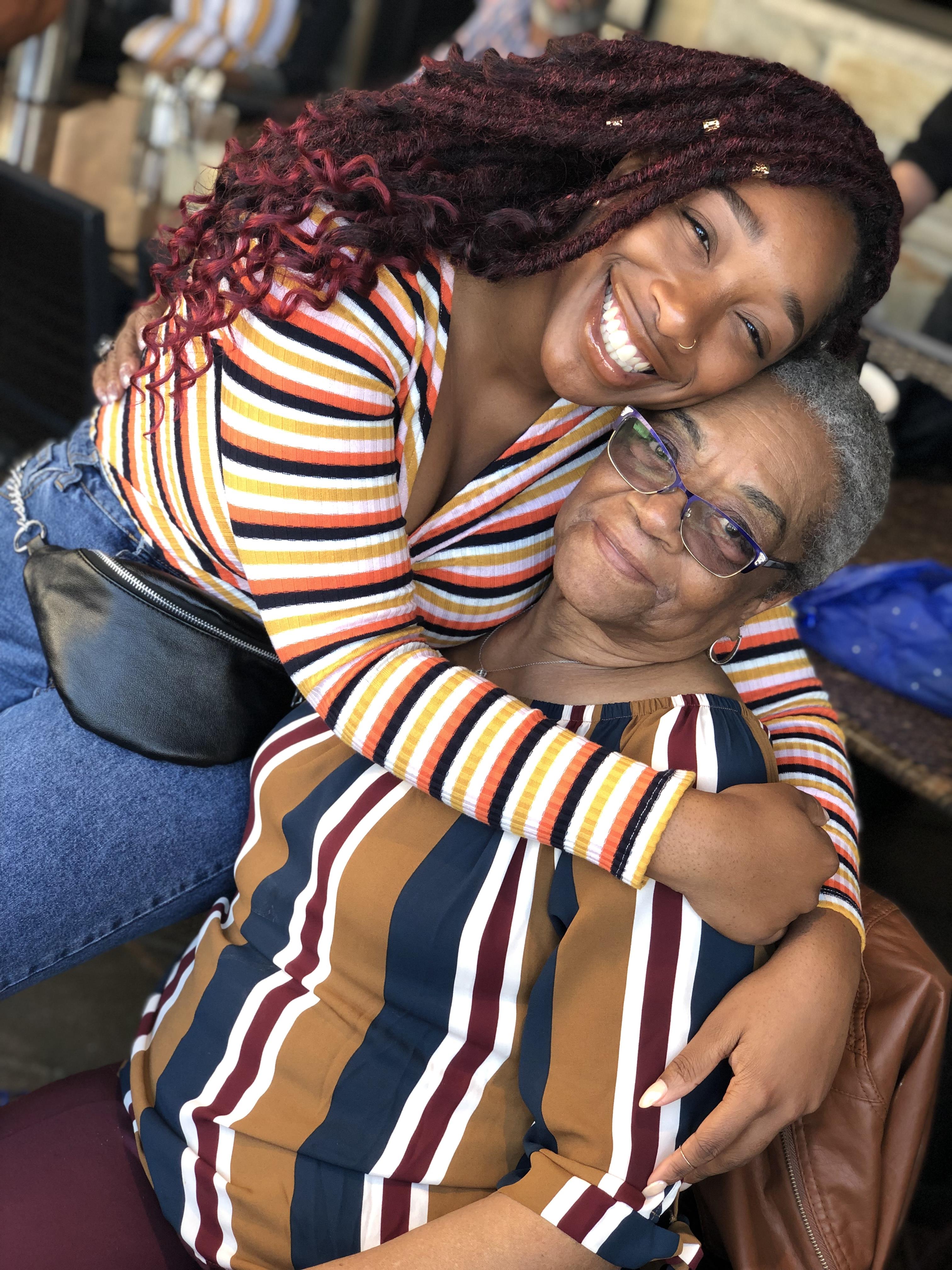A woman hugging an older woman