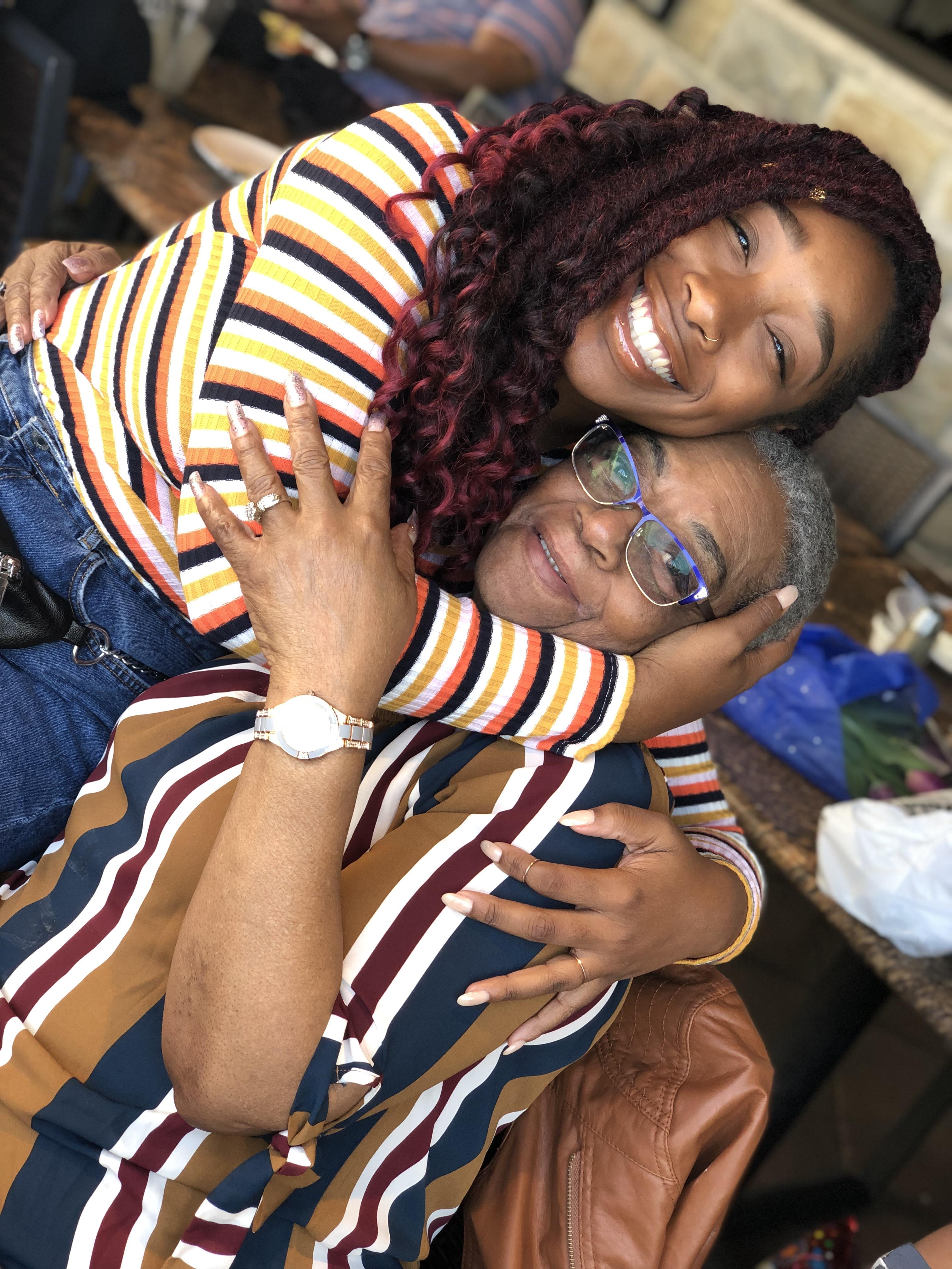 A woman hugging an older woman