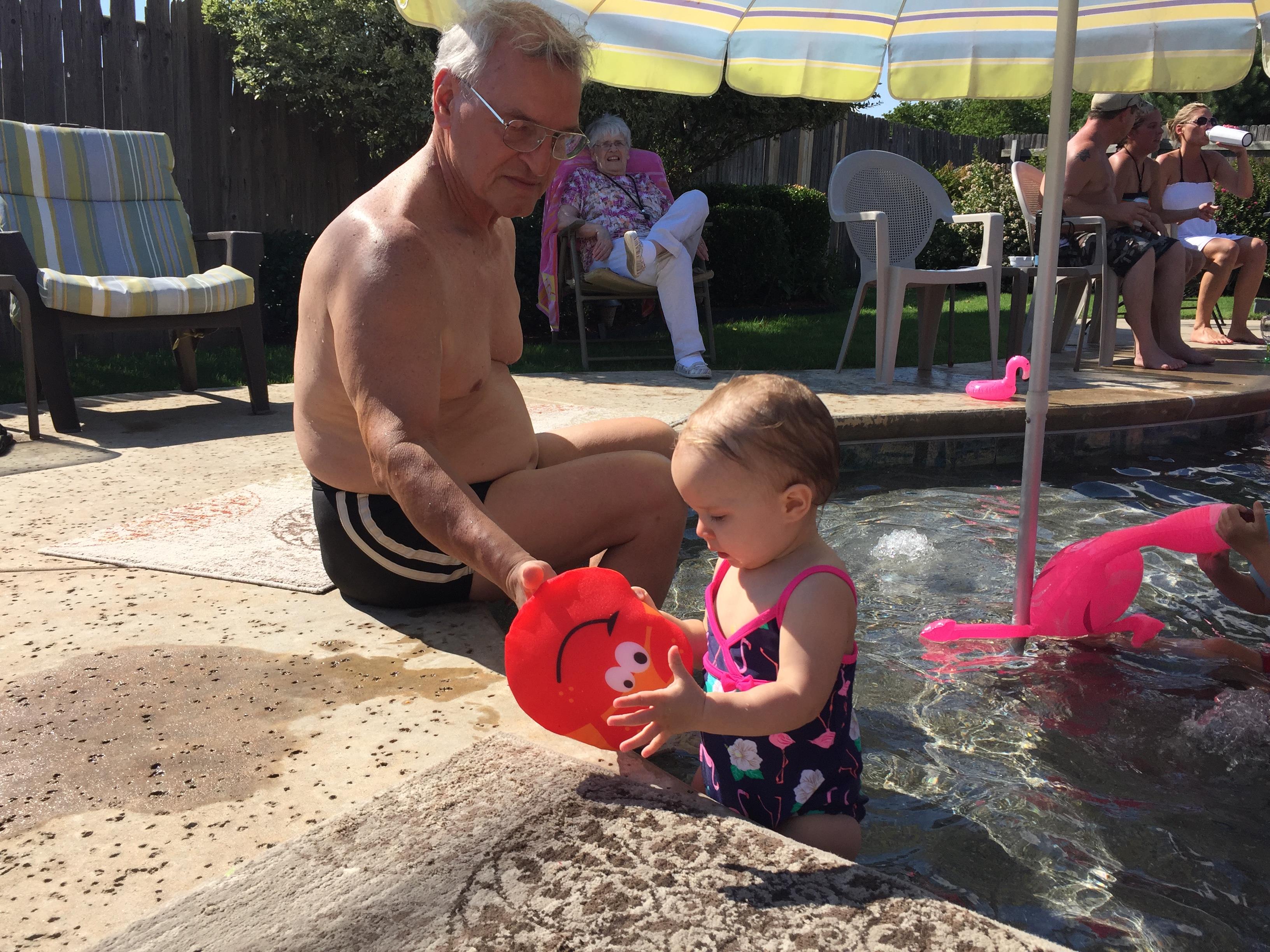 A man and a child in a pool