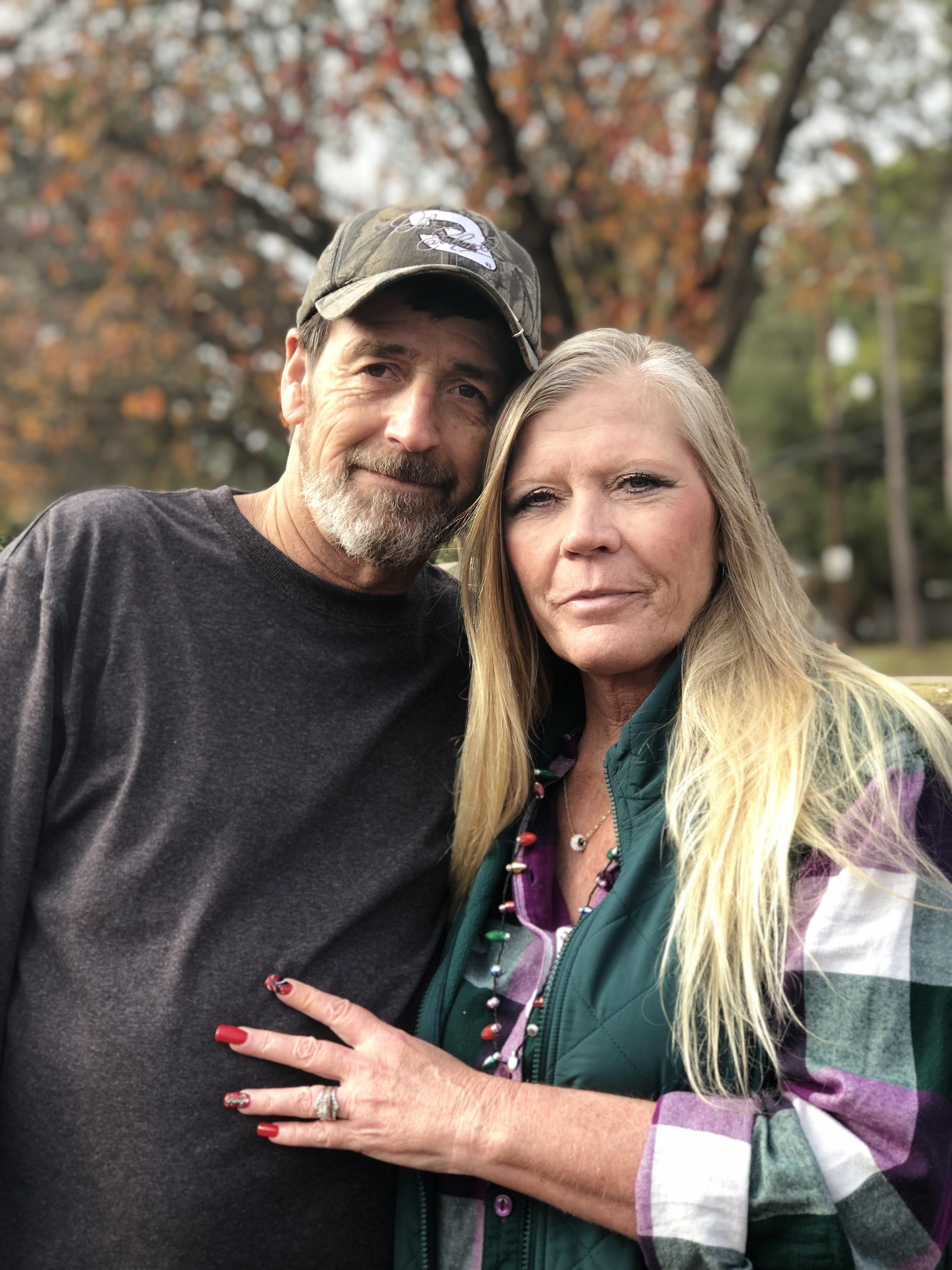 A man and woman posing for a picture
