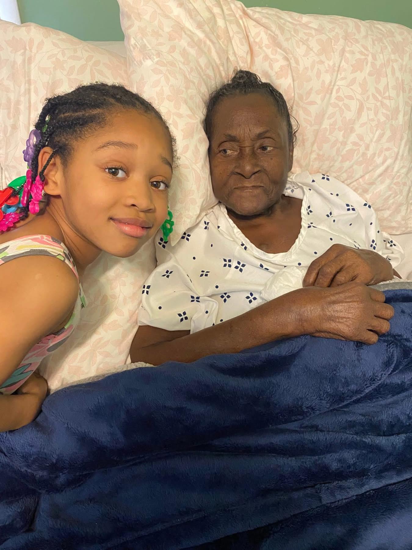 A girl and an old woman lying in bed