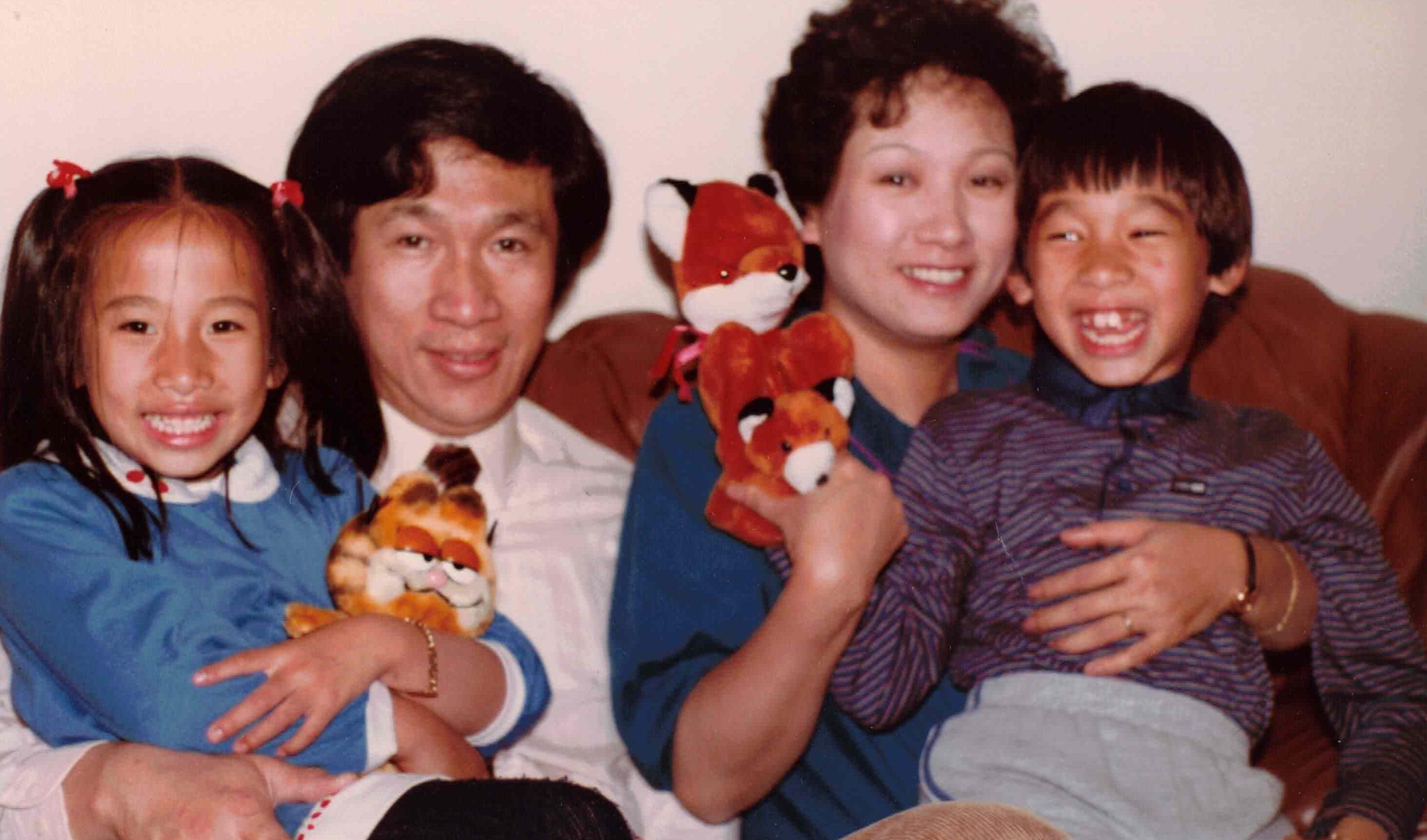 A family holding stuffed animals