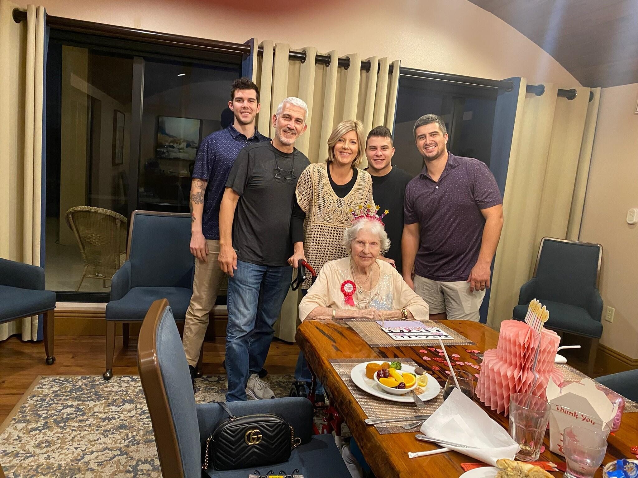 A group of people standing around a table