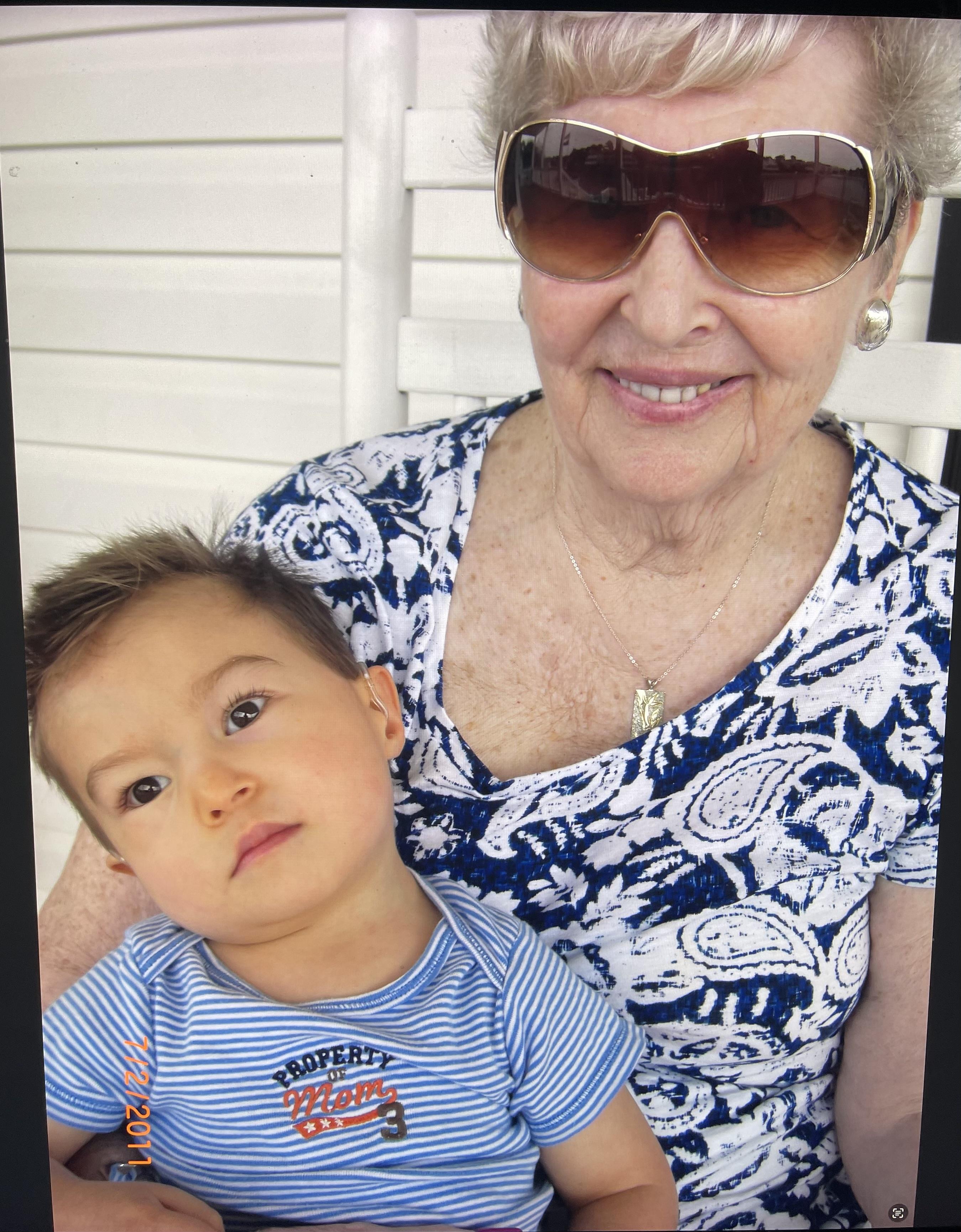 An older woman holding a baby