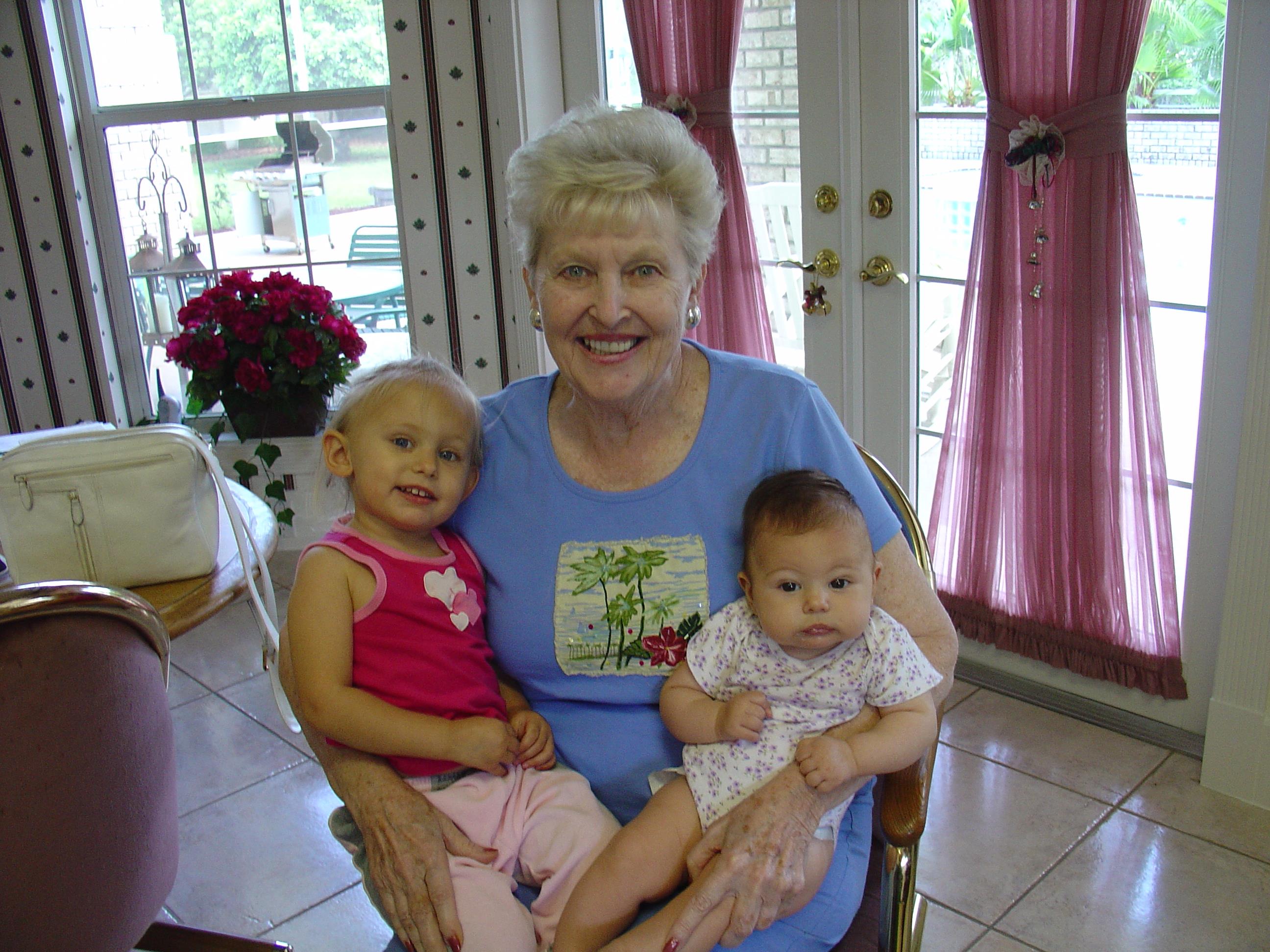 A woman holding two babies