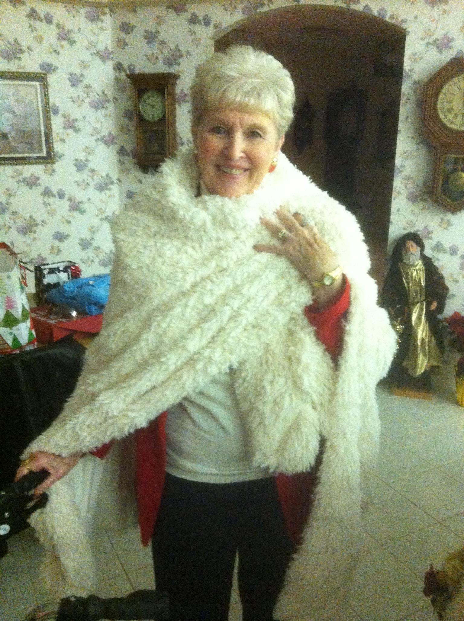 A woman in a white fur cape