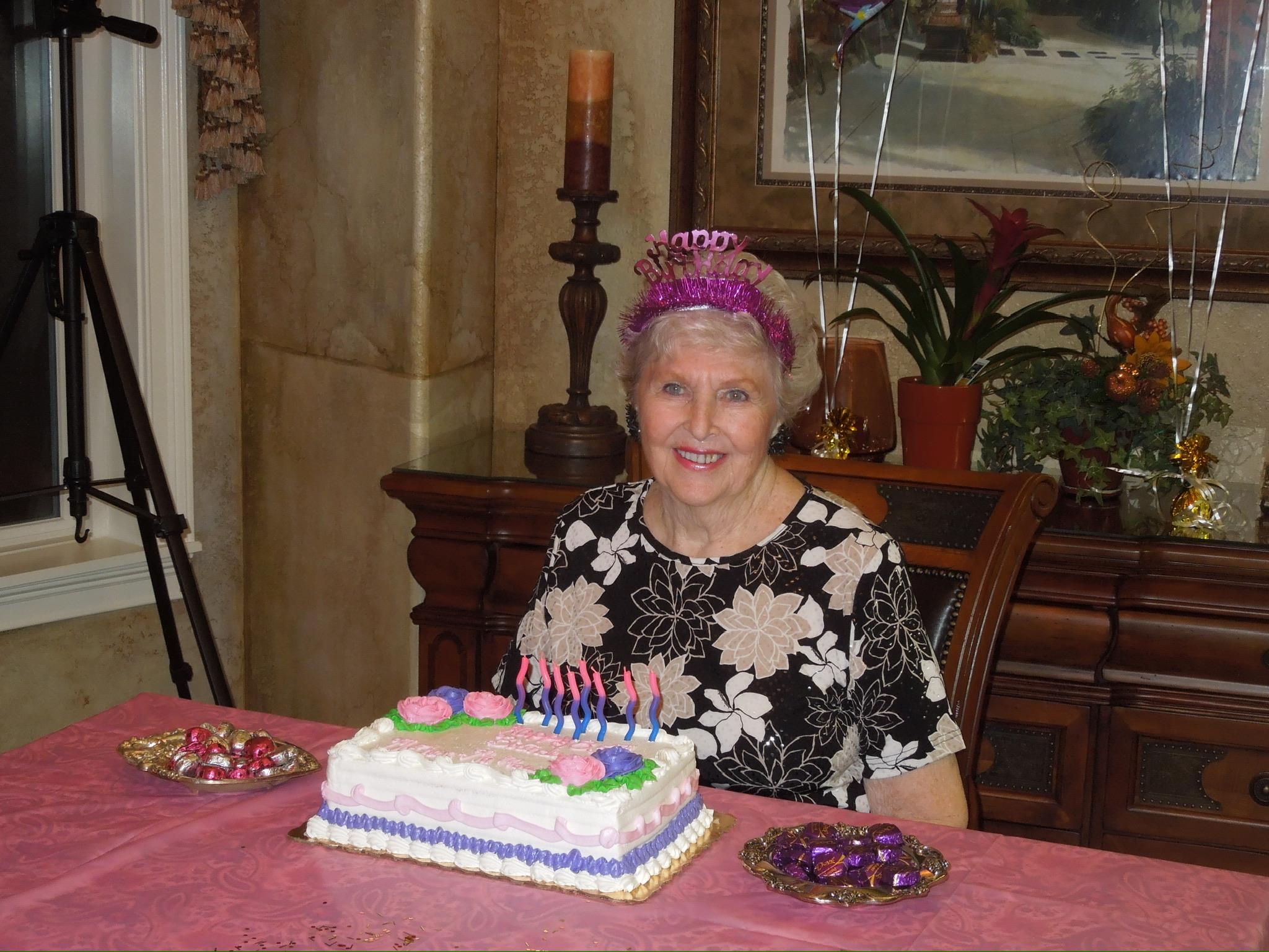 A woman sitting at a table with a cake