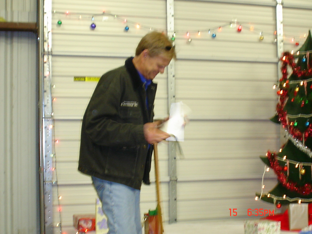 A man standing next to a christmas tree