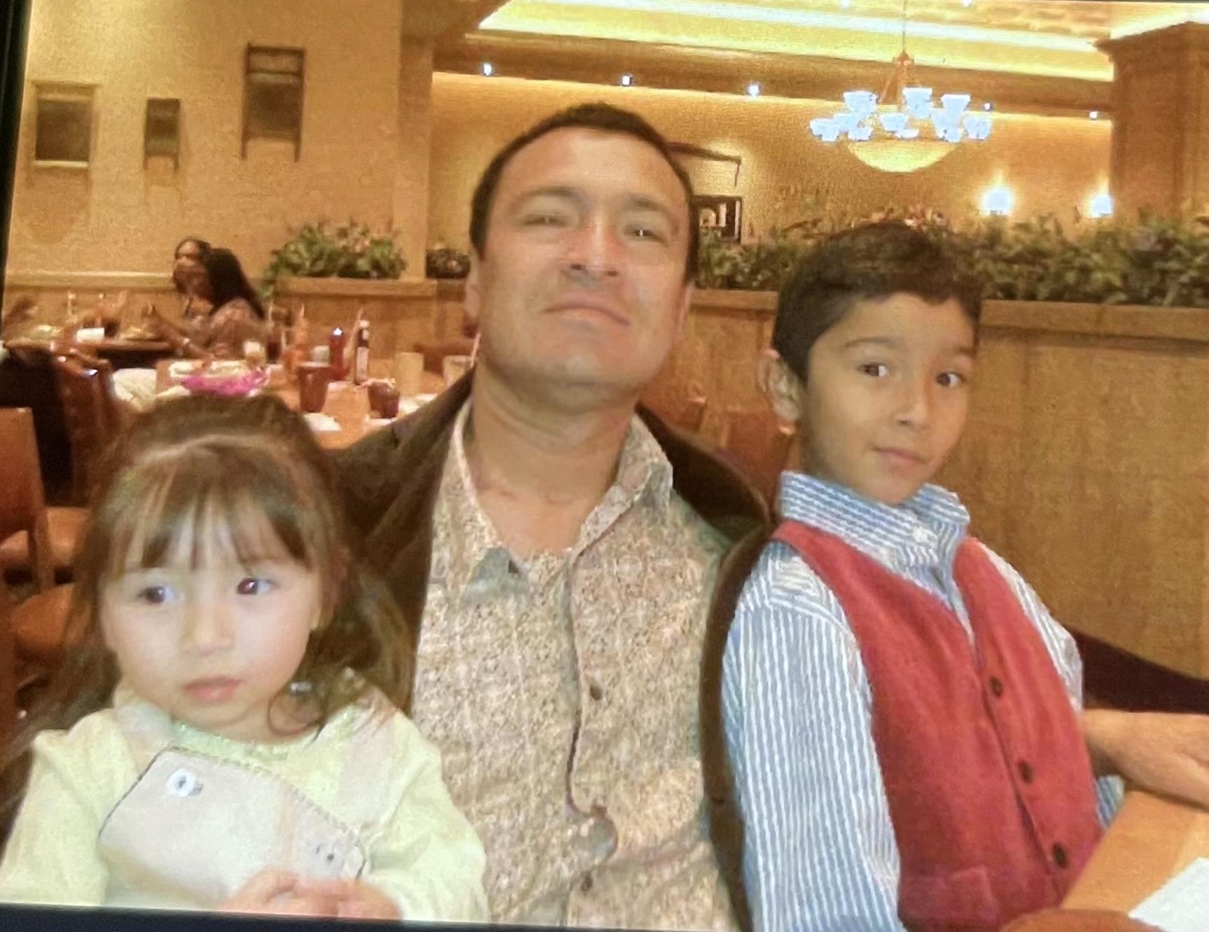 A man and two children posing for a picture