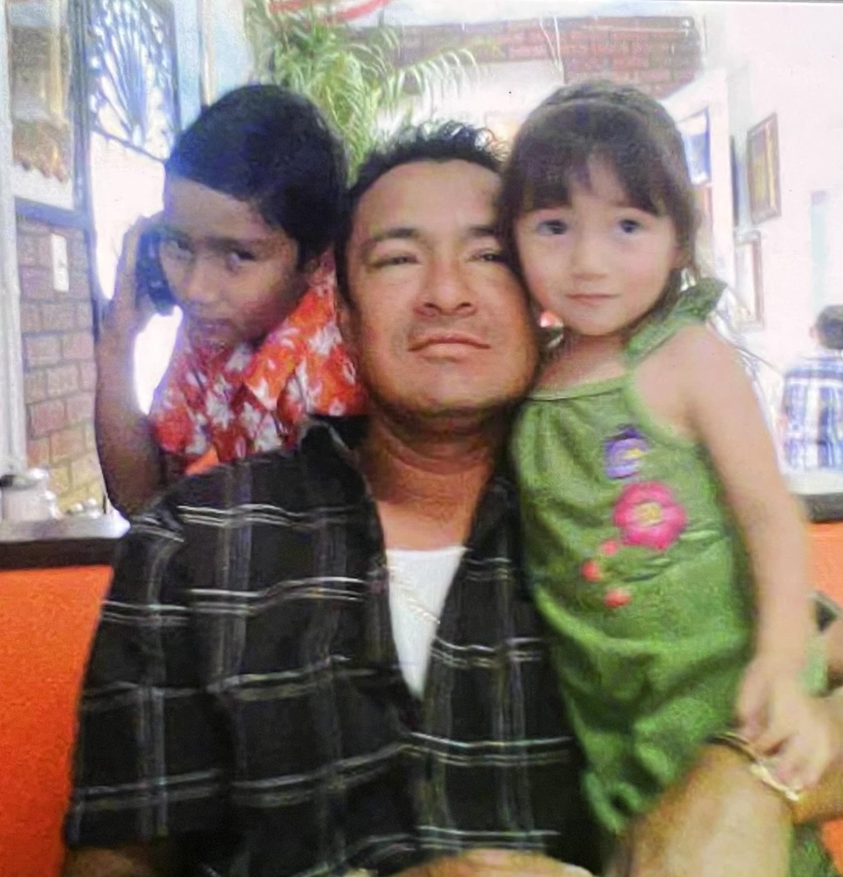 A man and two children posing for a picture