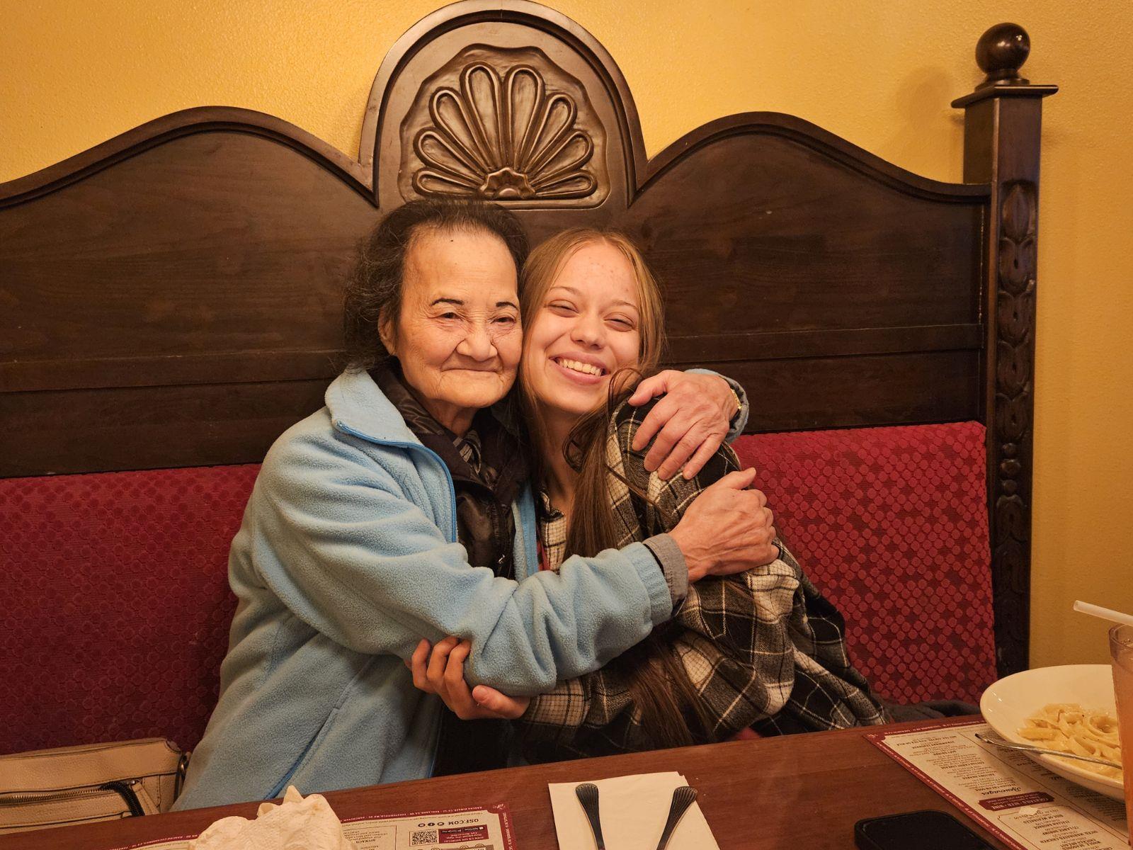 Two women hugging each other