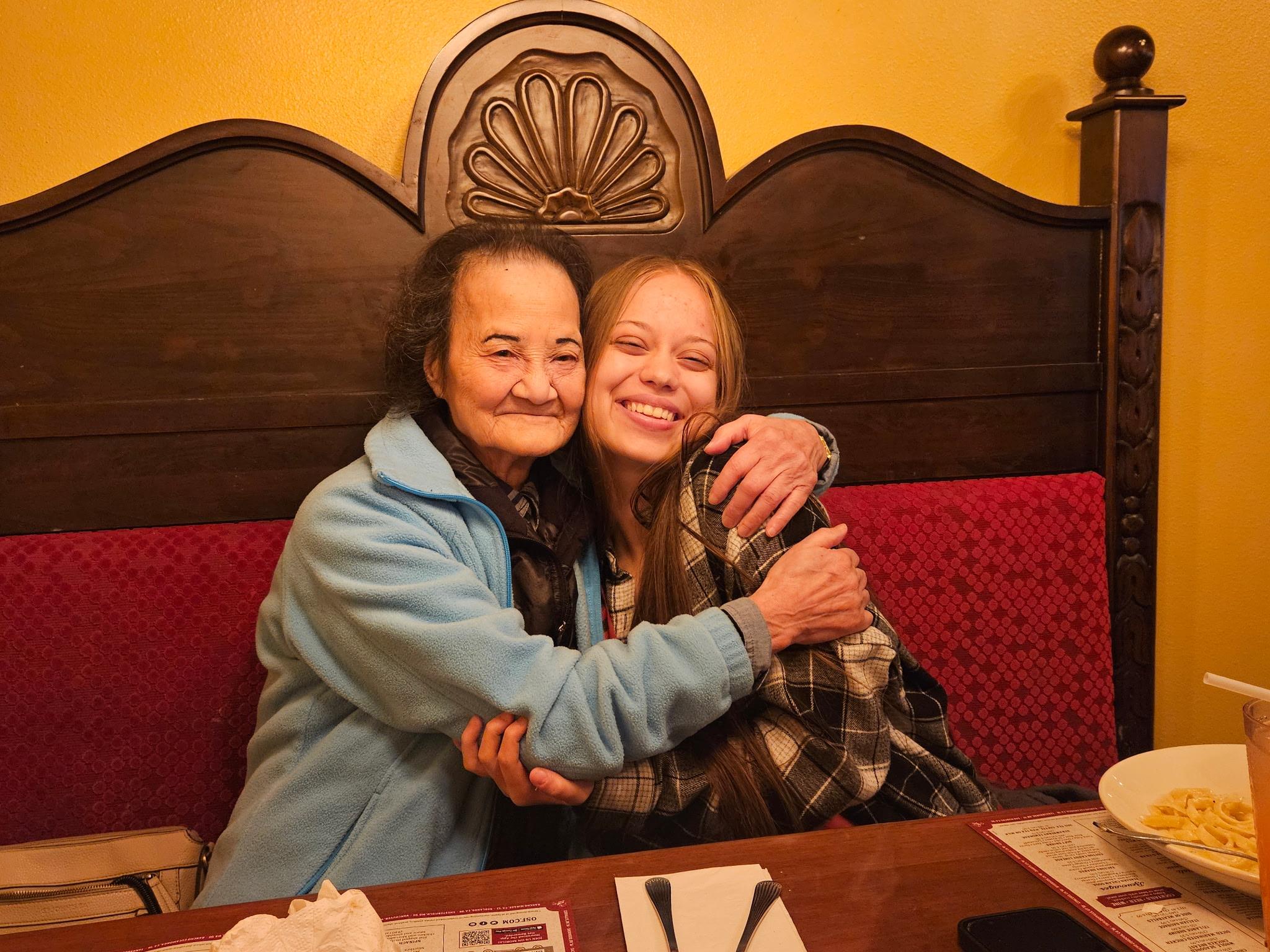 Two women hugging each other