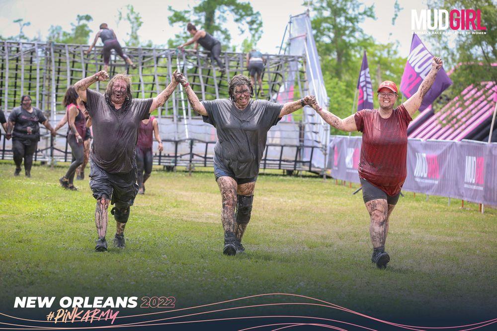 A group of people running in mud