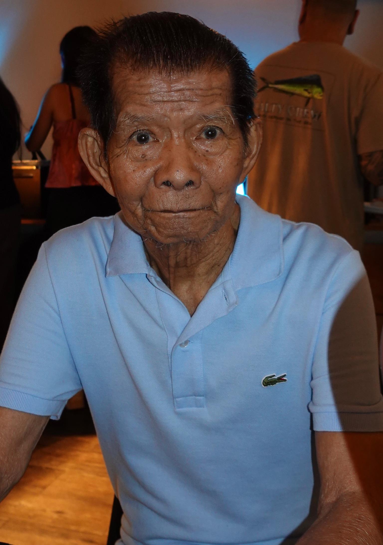 An old man in a blue shirt