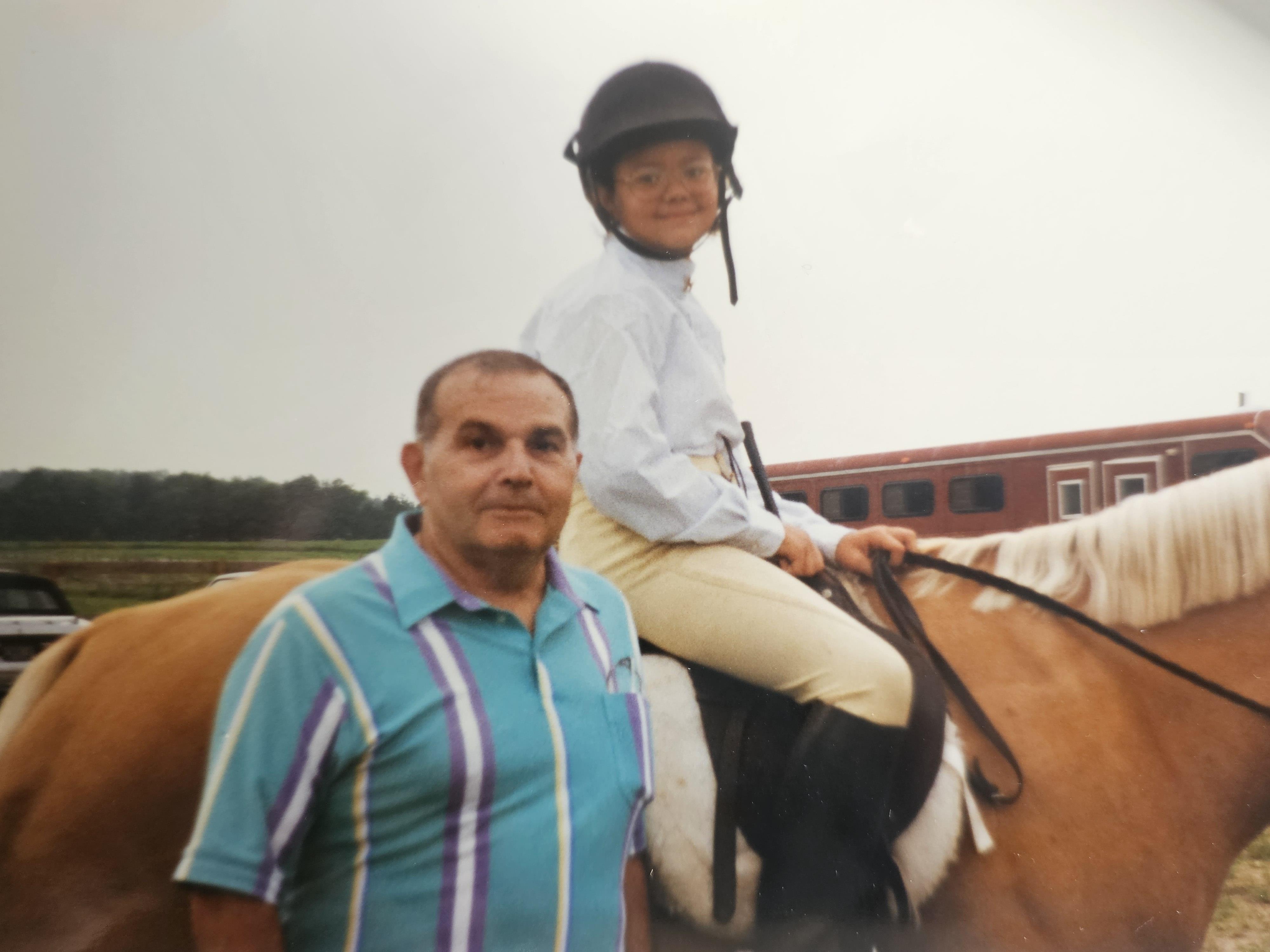A man and a child on a horse