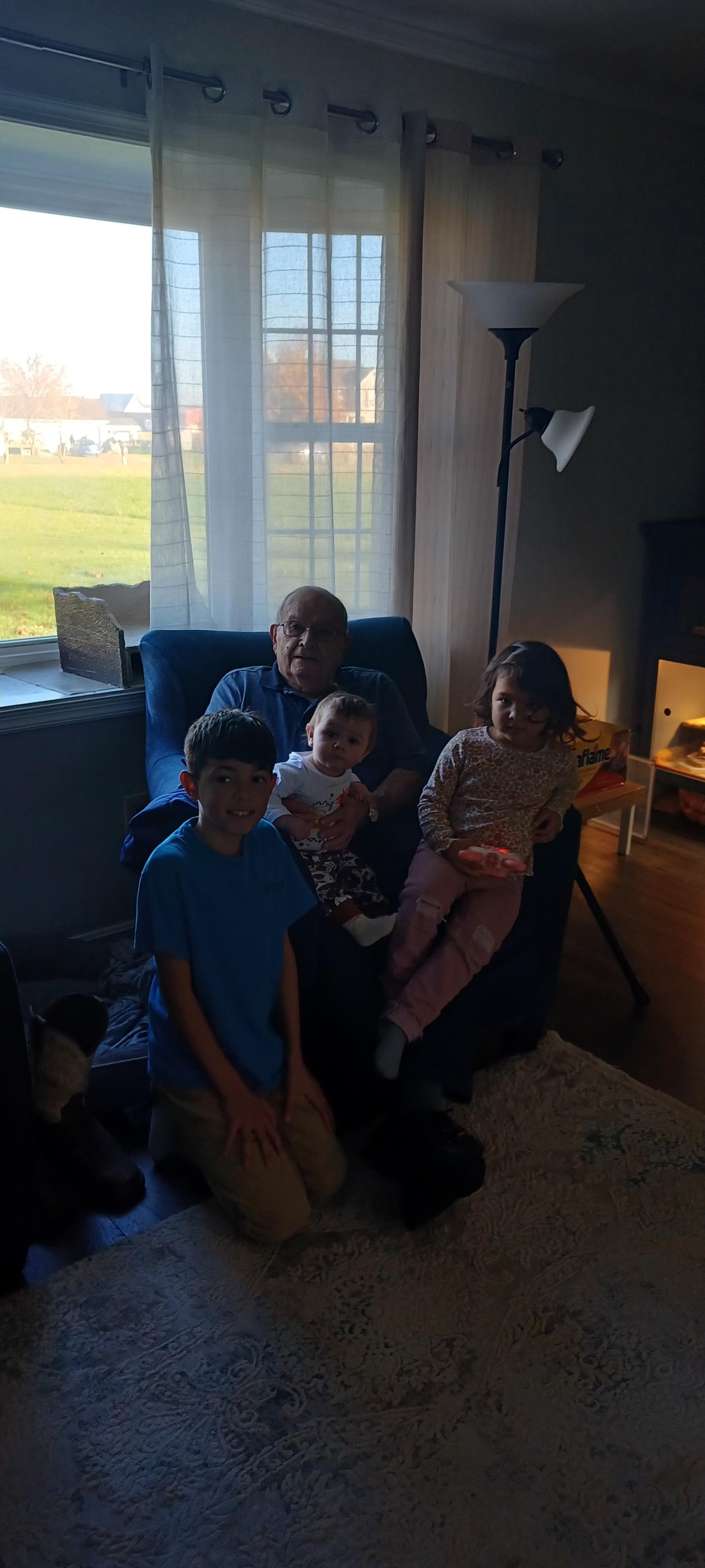 A man sitting on a chair with children
