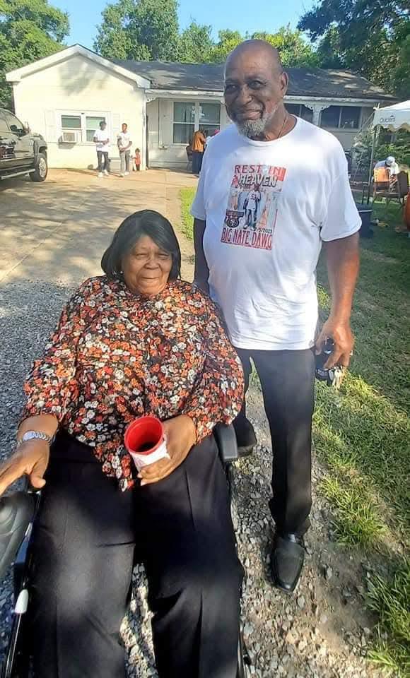 A man and woman in a wheelchair