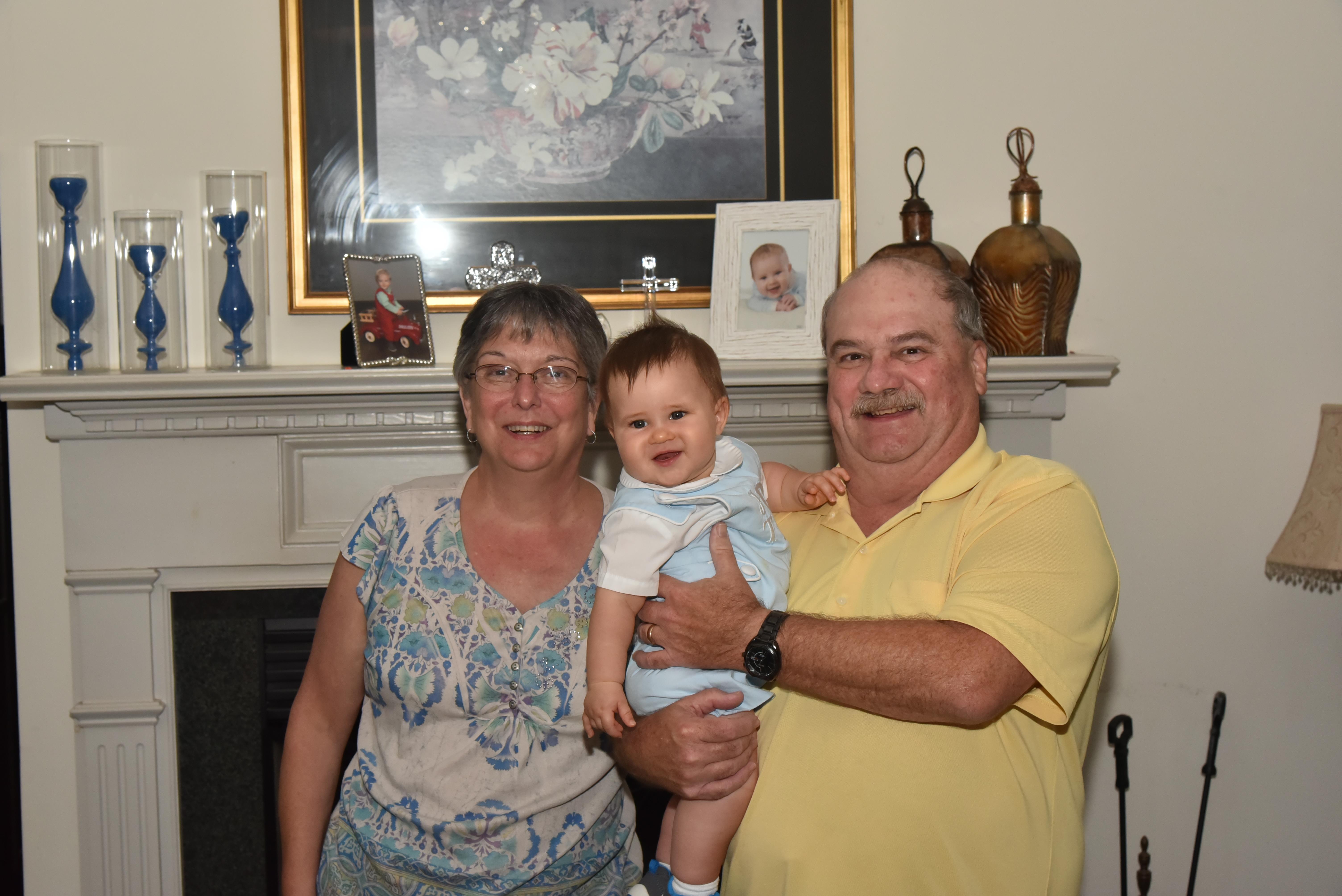 A man and woman holding a baby