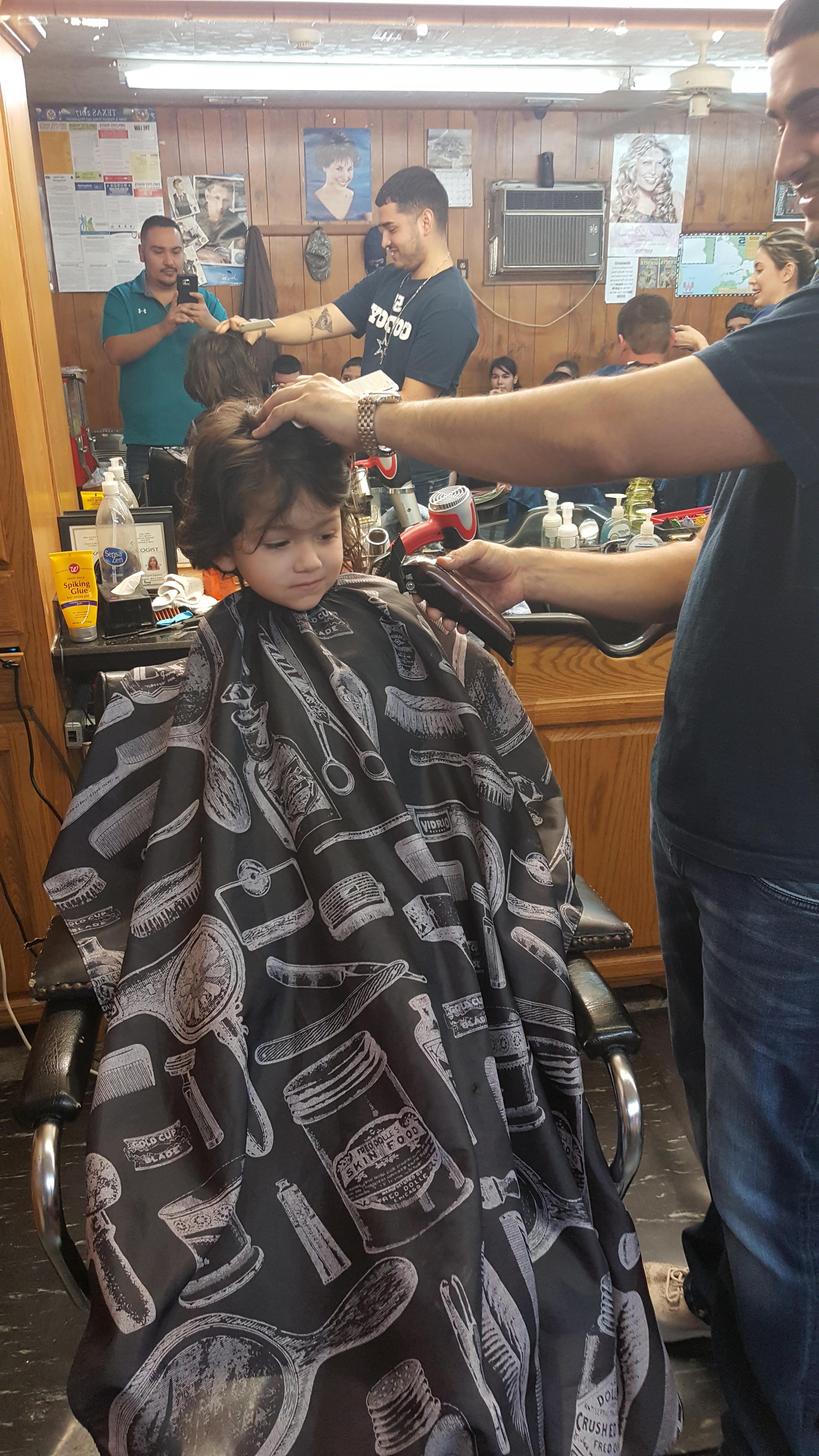 A man cutting a child's hair
