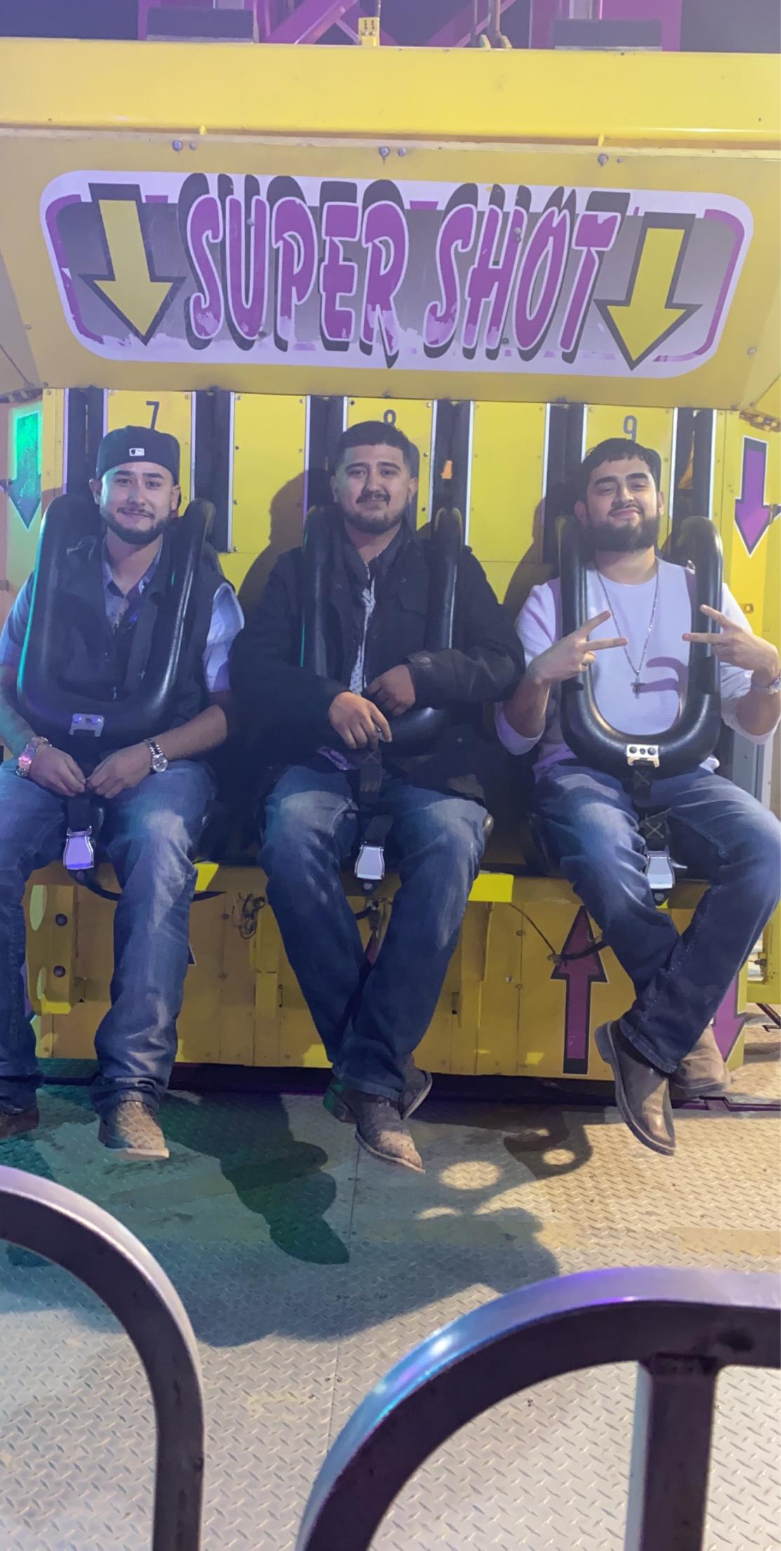 A group of men sitting on a yellow object
