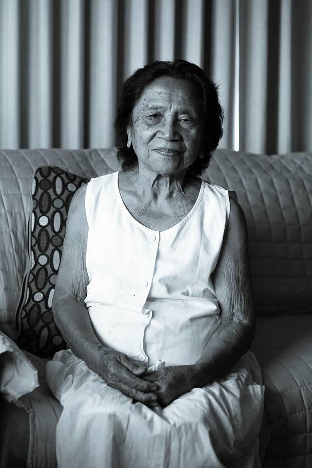 An old woman sitting on a couch