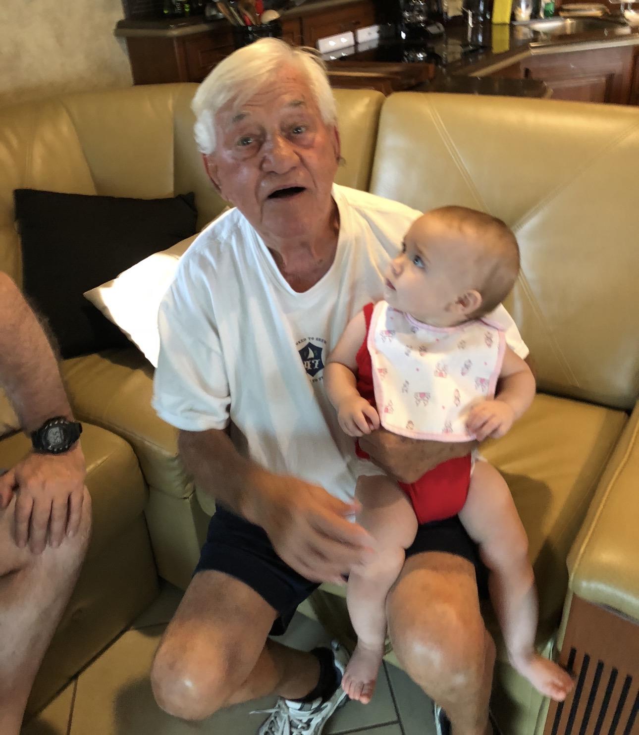 An old man holding a baby