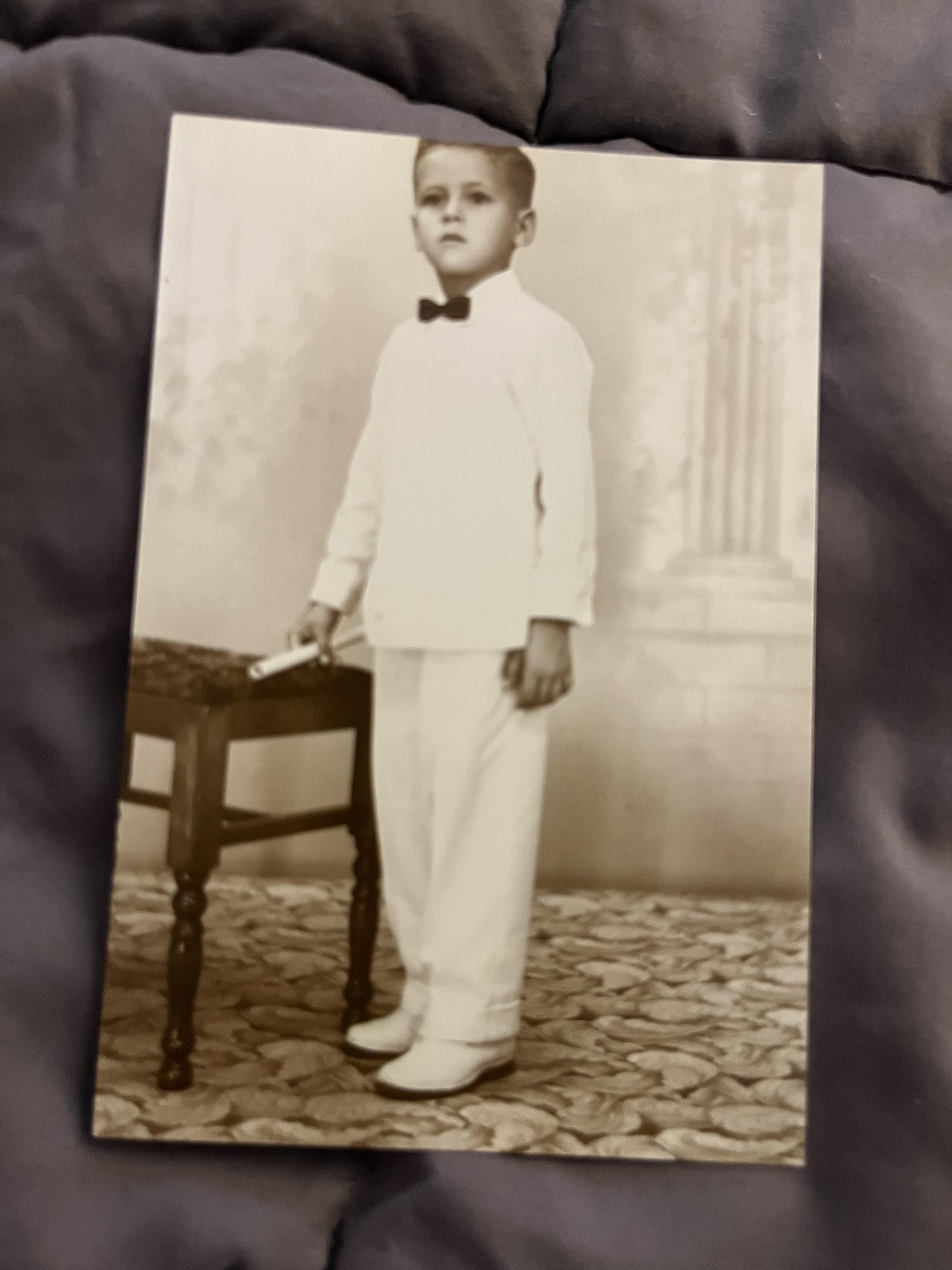 A boy in a white suit