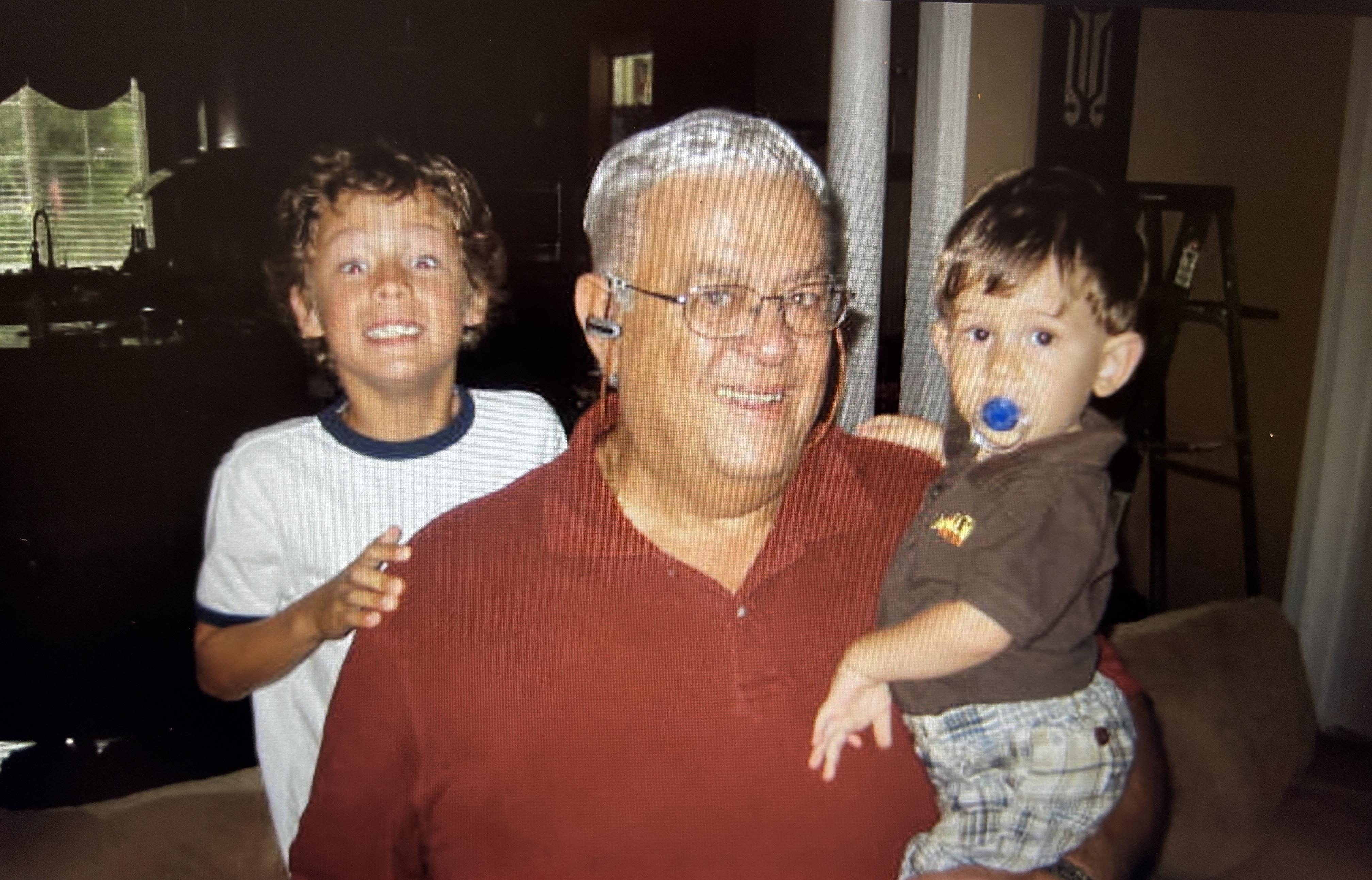 A man holding two boys