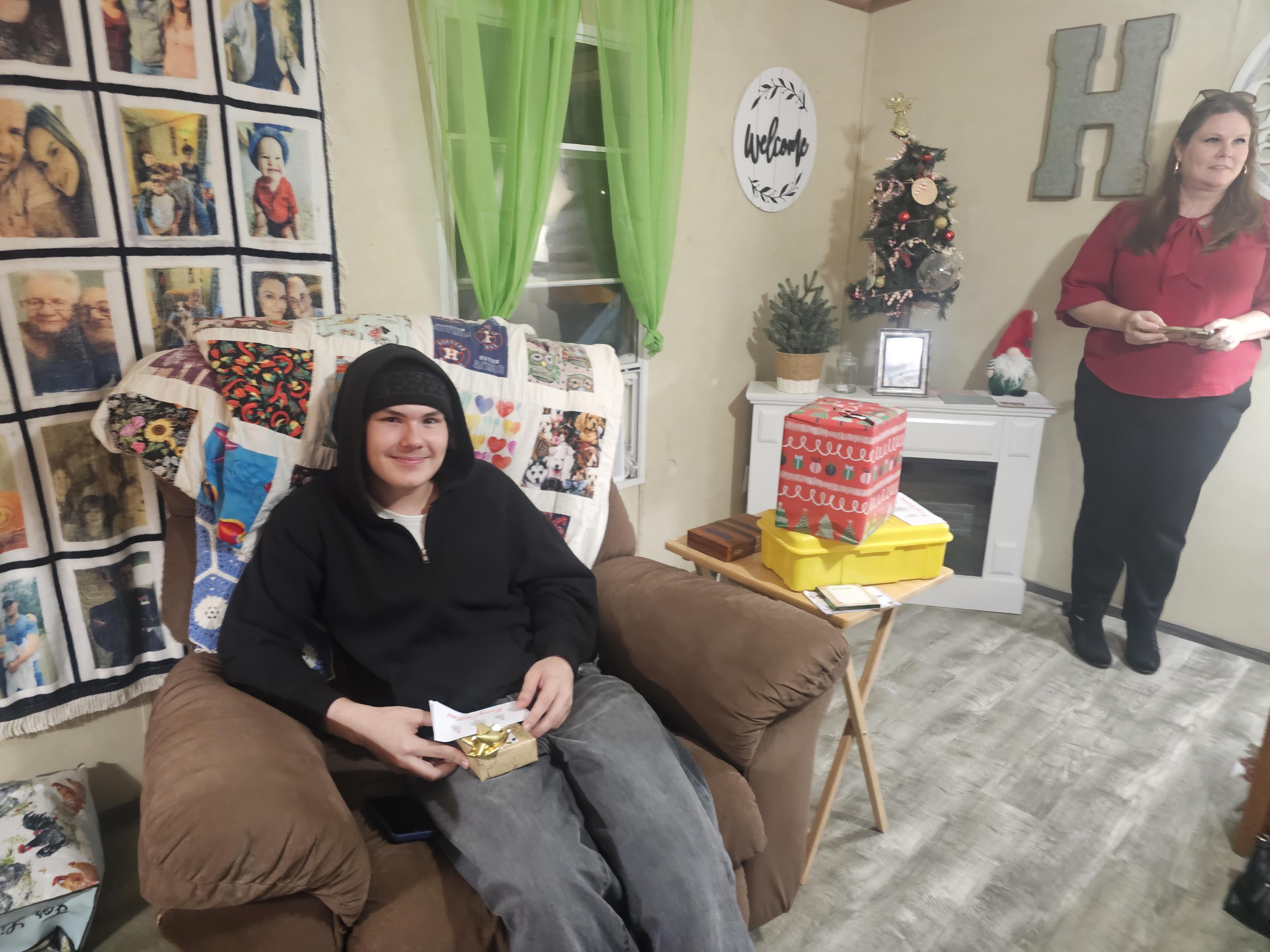 A man sitting in a chair with a gift